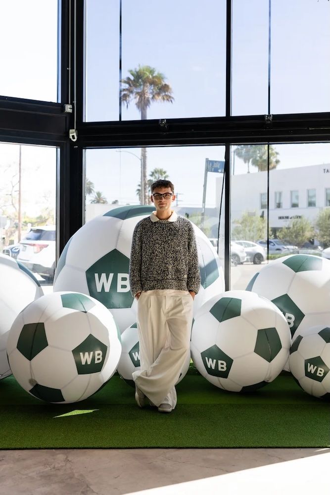 Man at the foreground with big footballs behind him with WB written on them. The man is Werner Bronkhorst