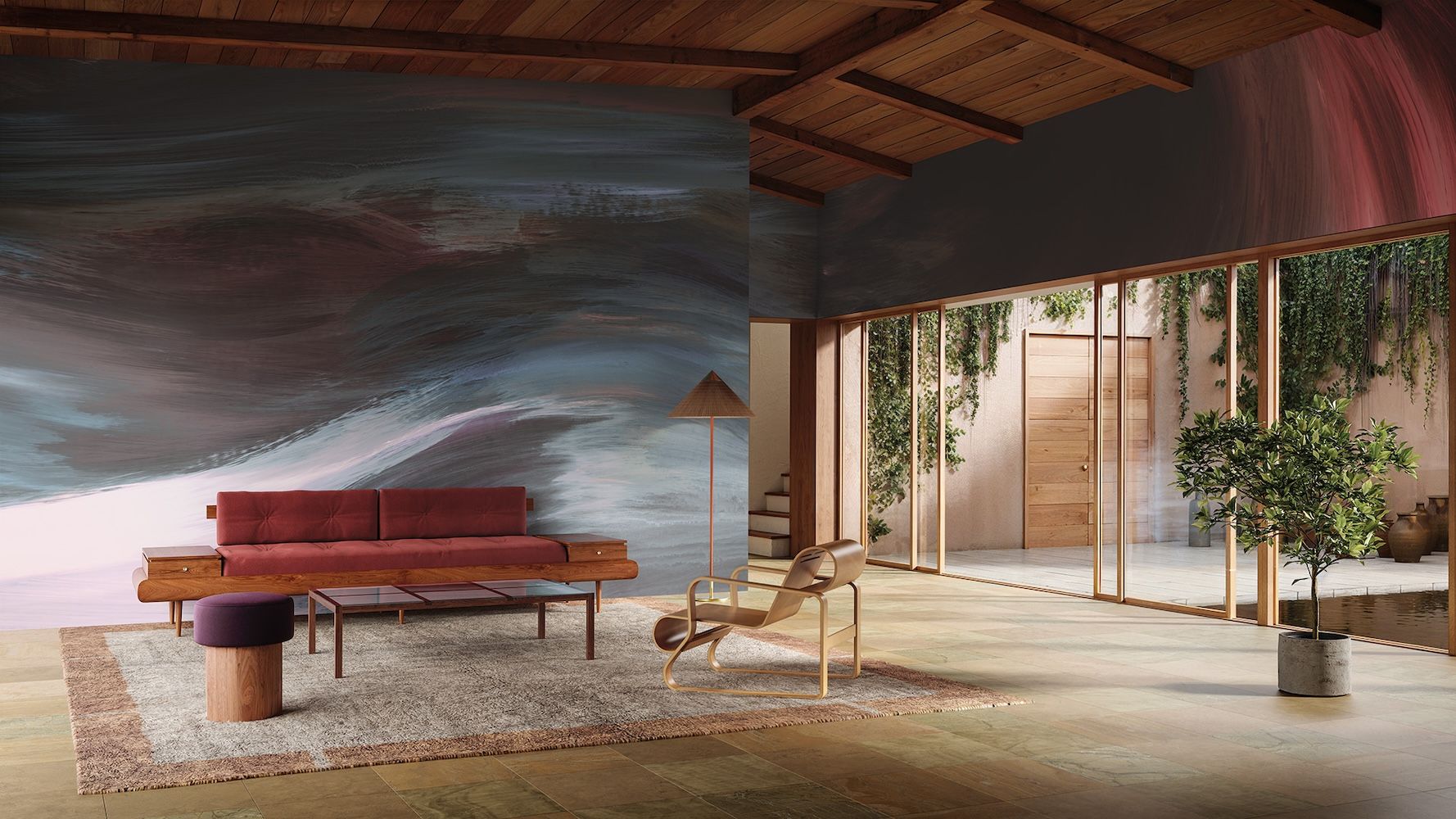 A red sofa in the backdrop of an interior set up with artwork in backdrop and rug