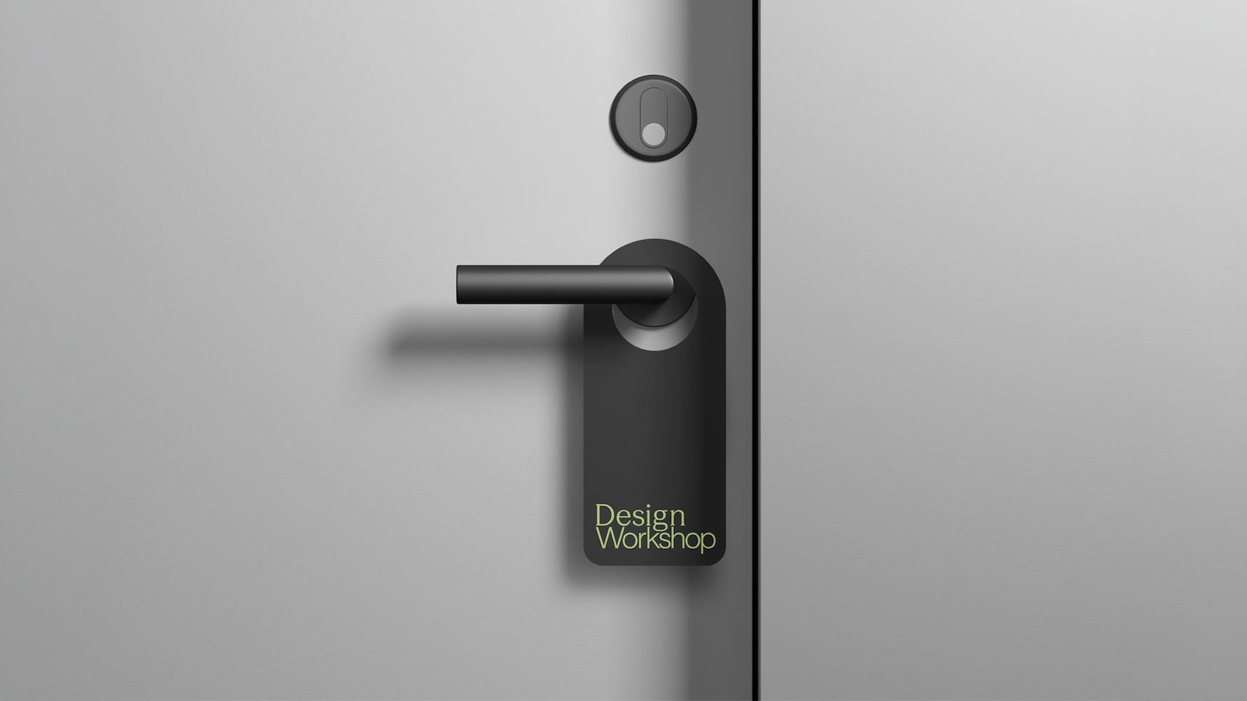 A doorhandle sign hanging with Design Workshop written on it