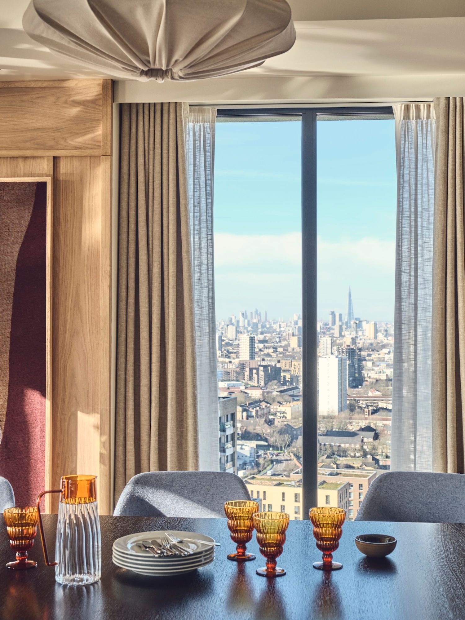 Way of Life Dining table with city view through window of London.