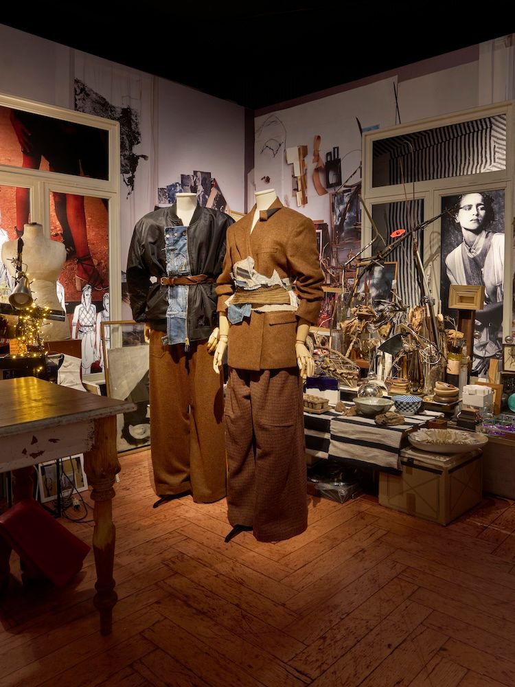 A fashion atelier set up with two mannequins and paraphernalia in the background