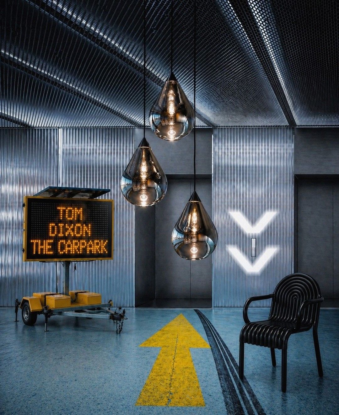 Tom Dixon display in a car park with signage, lighting and a chair