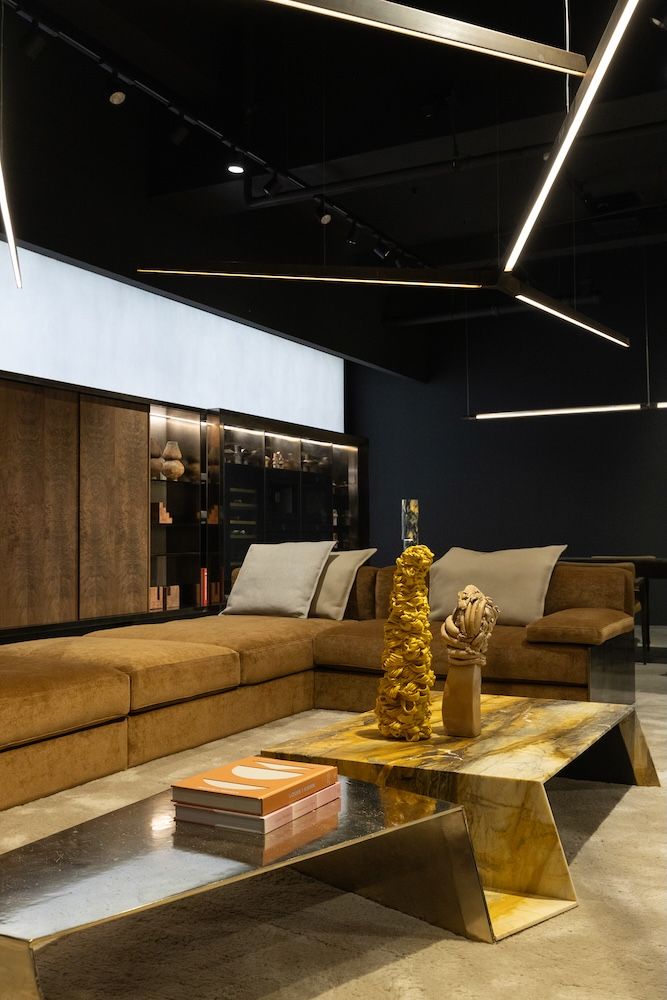 The interior of Italian furniture brand Henge with yellow sofa and lighting above