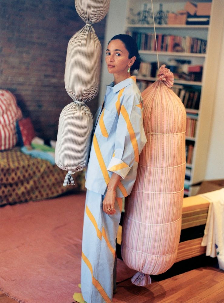 Laila Gohar in yellow and red patterned outfit in her apartment