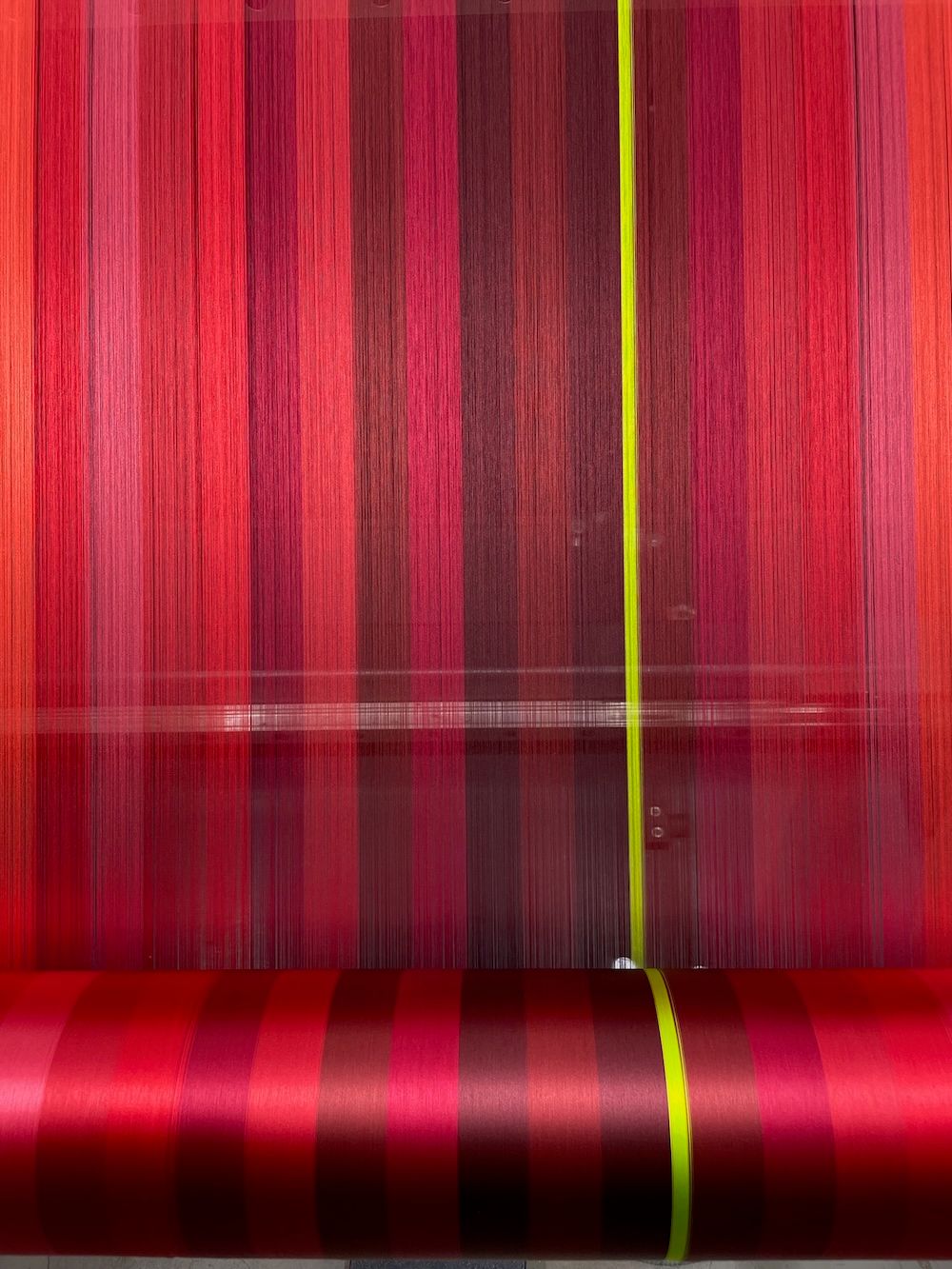 Silk roll featuring red tones with a bold yellow stripe