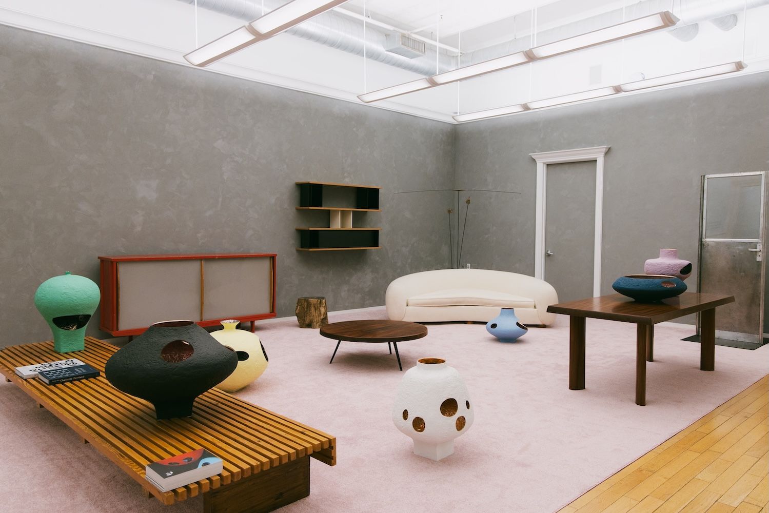 A set up of furniture in an exhibition setting 