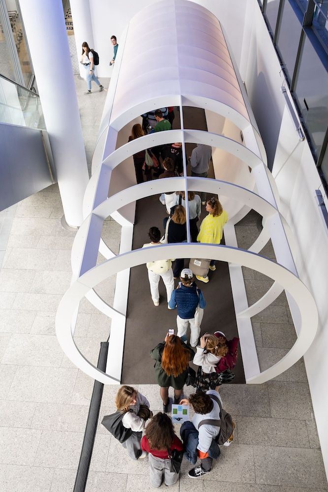 Crowds walking through a circular gateway