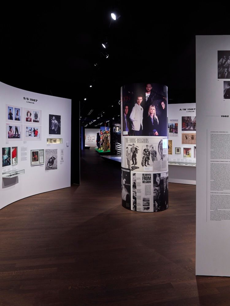 Exhibition display with images stuck on the wall and pillars with exhibition featured on them 