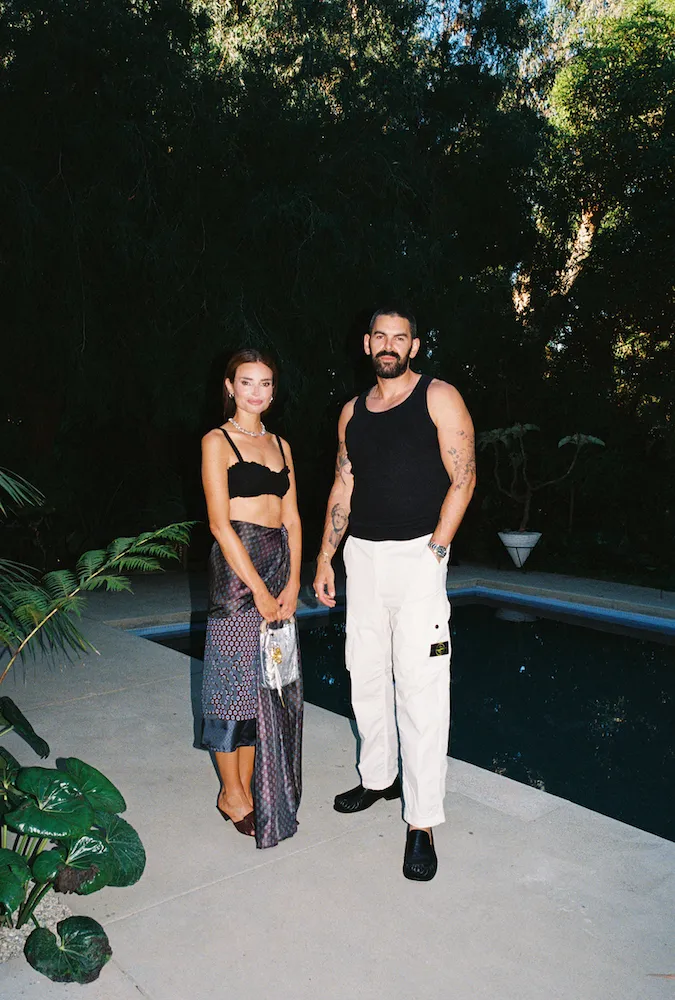 A woman and a man posing in front of a pool who are design studio Ome Dezin