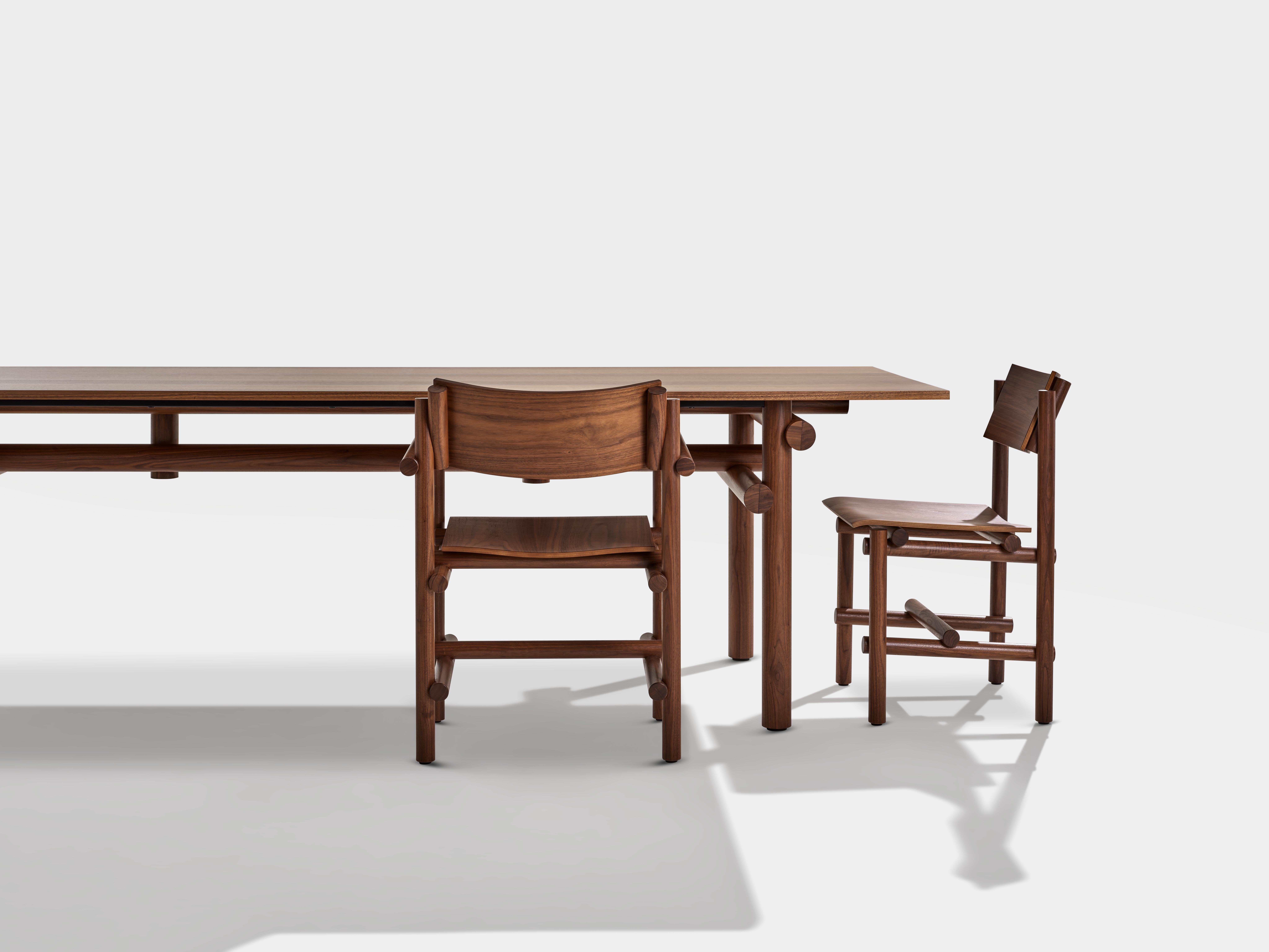 Table and chairs by Knoll in warm wood