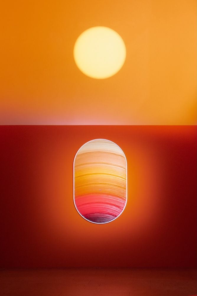 Colours of the sunset or sunrise in red to orange with artwork in the bottom of the image