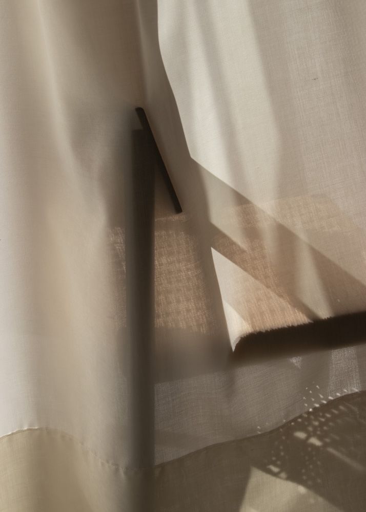 Beige sheer fabric draped across the screen 