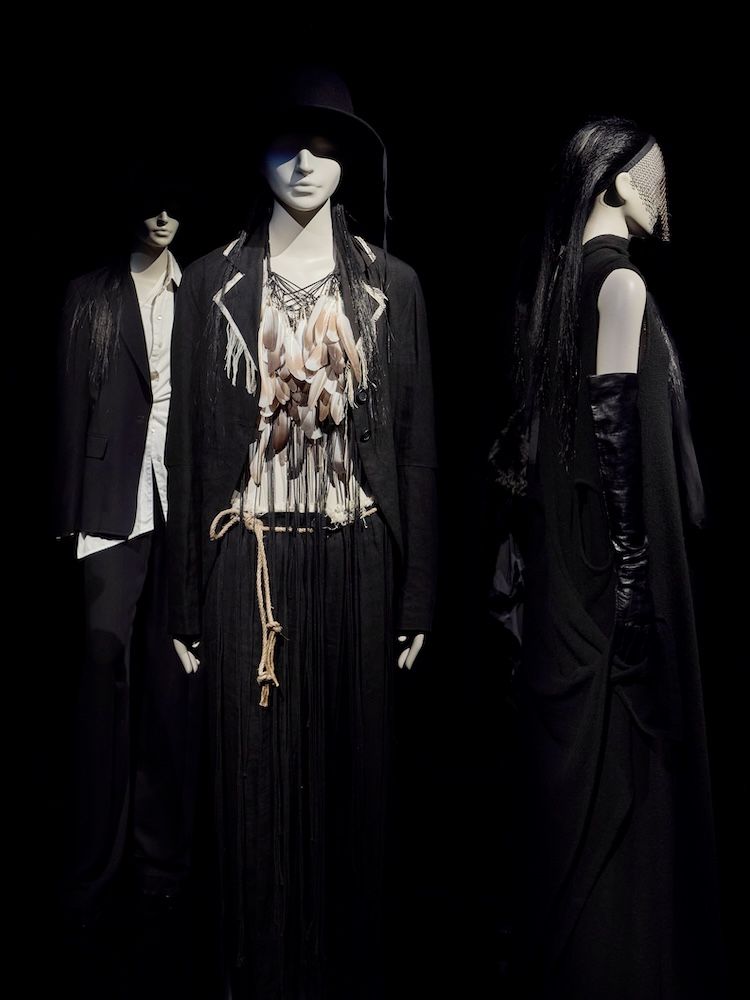 Mannequins on a black backdrop with hats and veils 