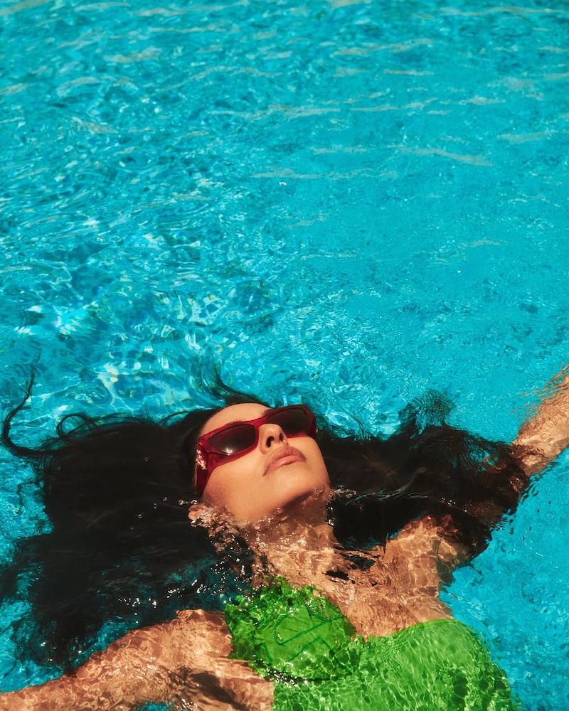 Woman in pool with green swimsuit on