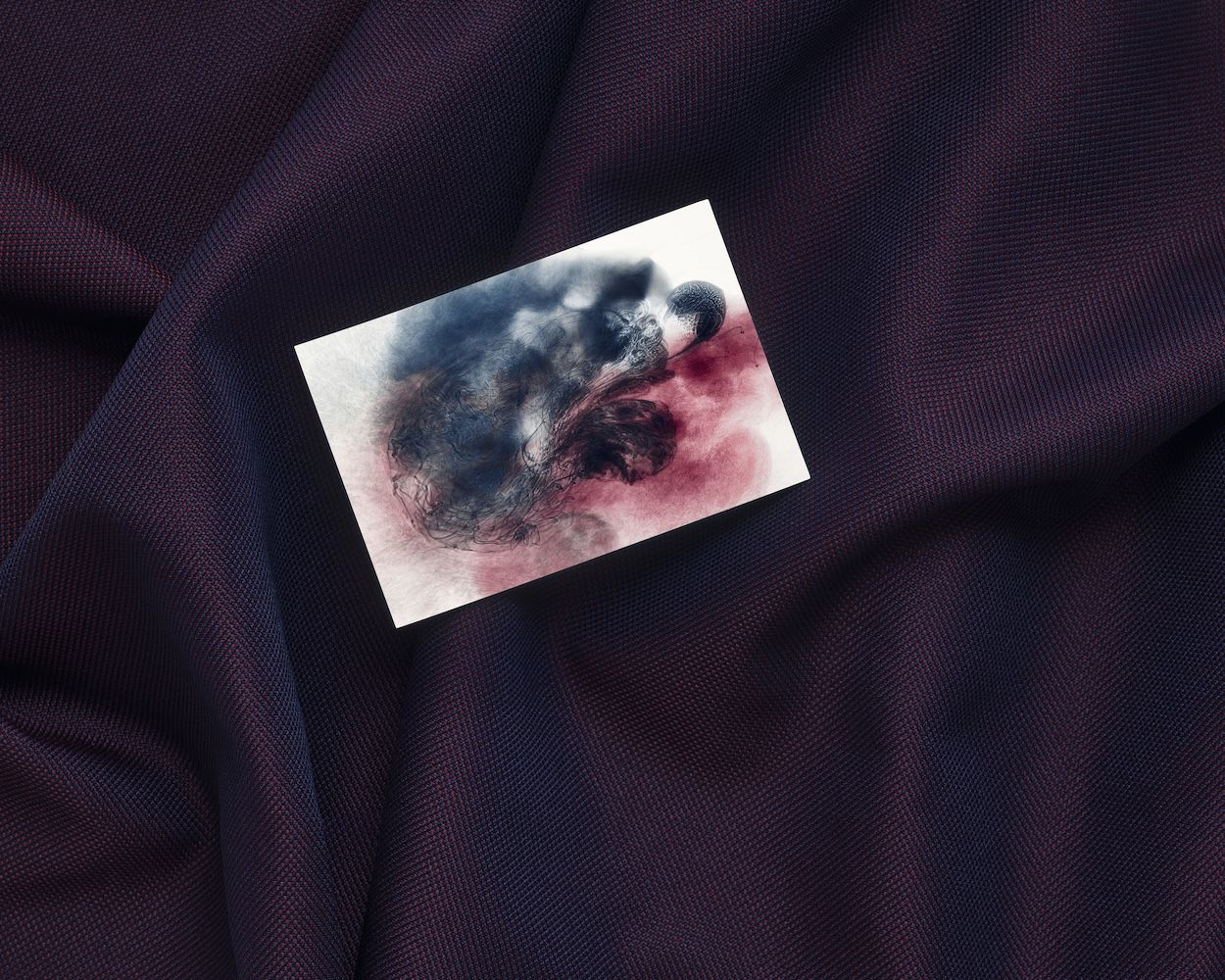 Dark stain image against purple backdrop fabric 