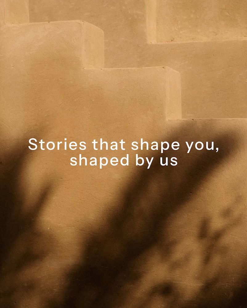 A desert-like backdrop with shadows with words in white on the foreground