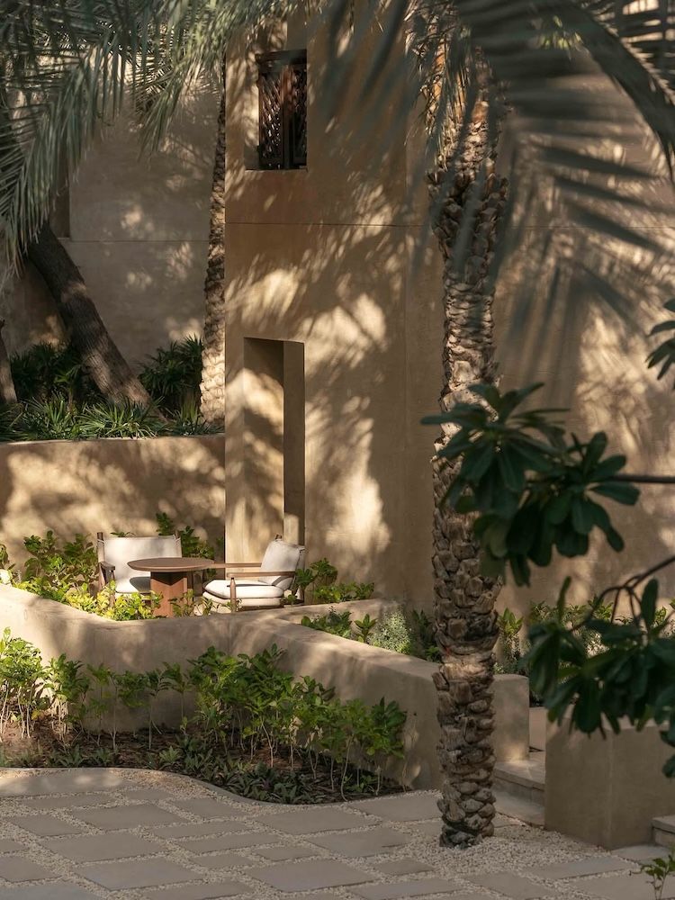 A resort-like scene with palm trees and green in the foreground