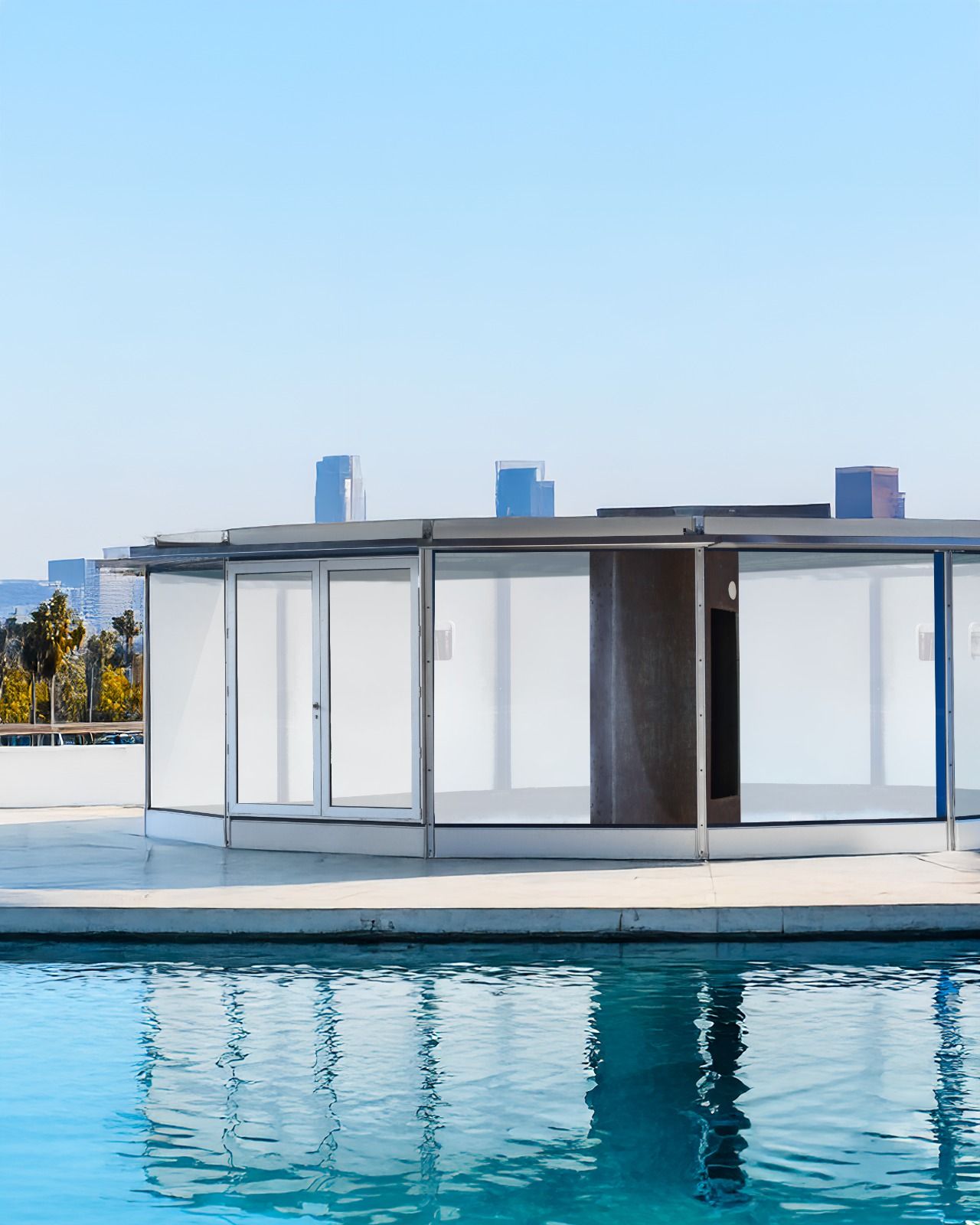 Image of Jean Prouve gas station with blue sky background and blue crisp water in foreground