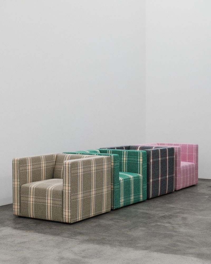 Four armchairs in a row in beige, green, purple and pink with Sahco fabric