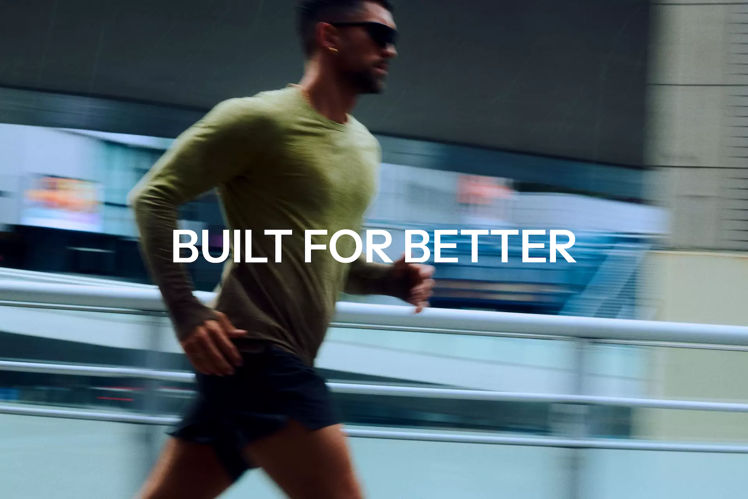 A man running with blurred background and 'Built for Better' in the foreground in white writing