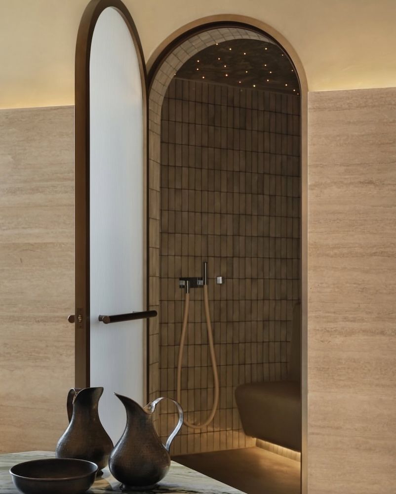 A shower set up with cream, sand coloured interiors 