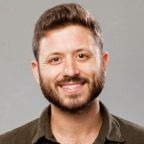 Smiling man with dark hair and a beard.