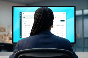 A person views a business application on a computer monitor from behind.
