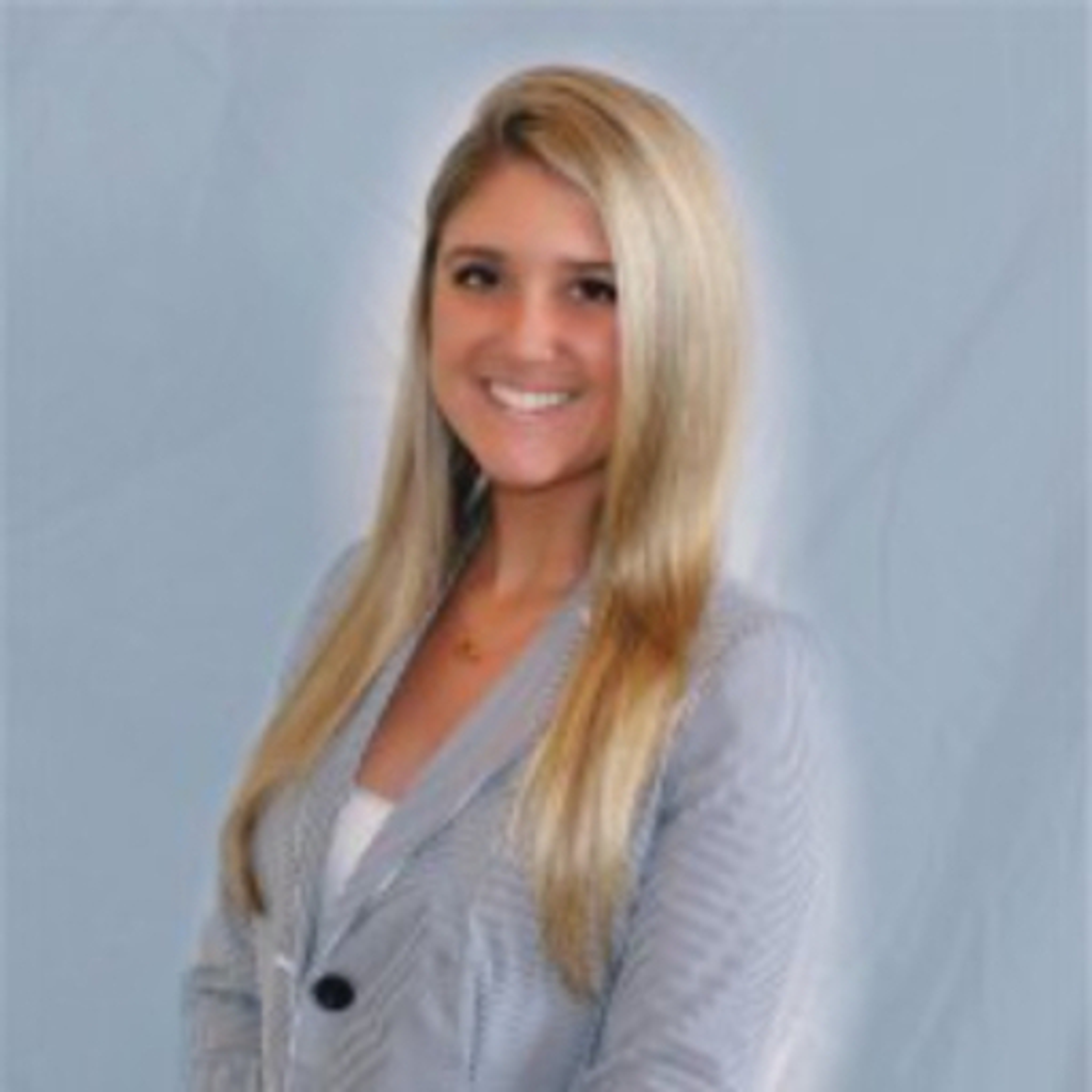 A smiling young woman with long blonde hair wearing a striped blazer.