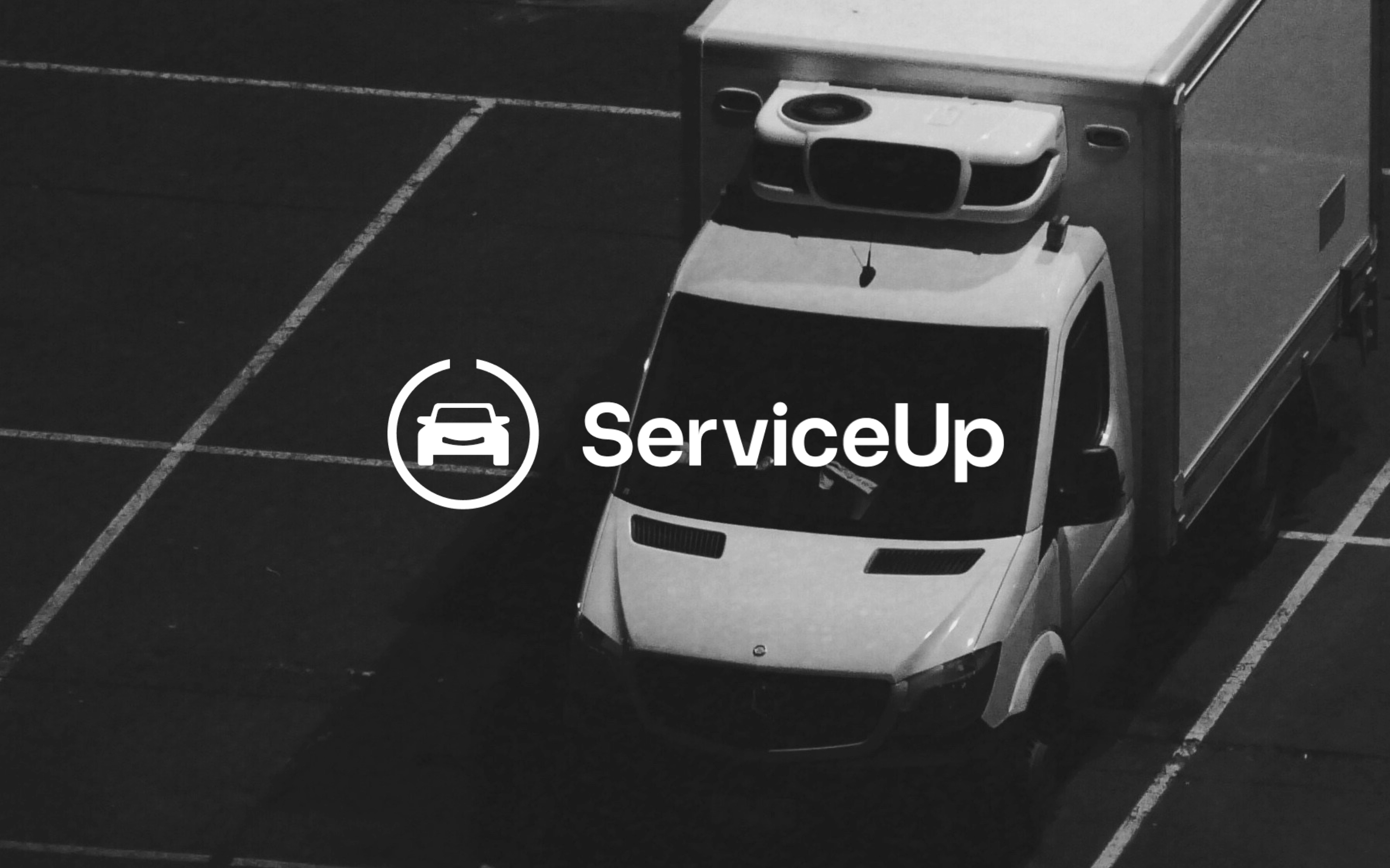 a black and white photo of a serviceup truck
