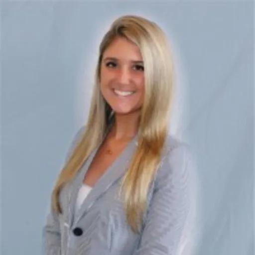 A smiling young woman with long blonde hair wearing a striped blazer.