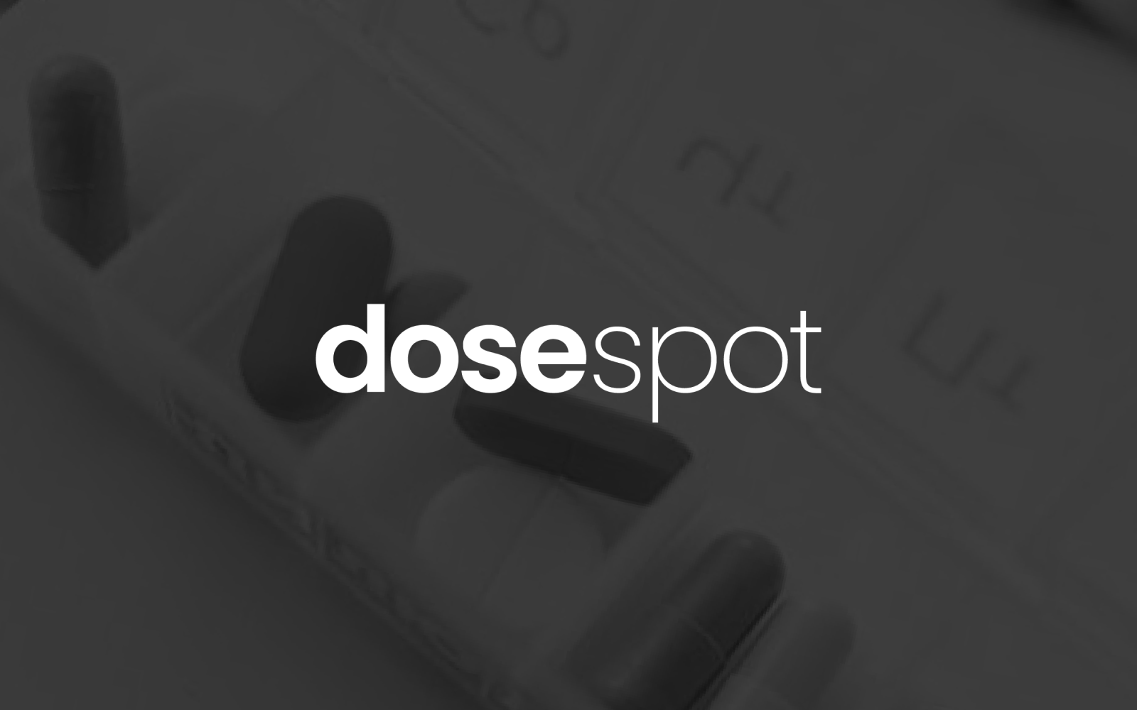 a black and white photo of pills and the word dosespot