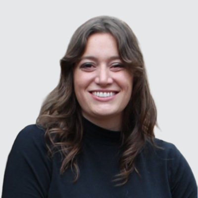 A smiling woman with long brown hair wearing a black turtleneck.