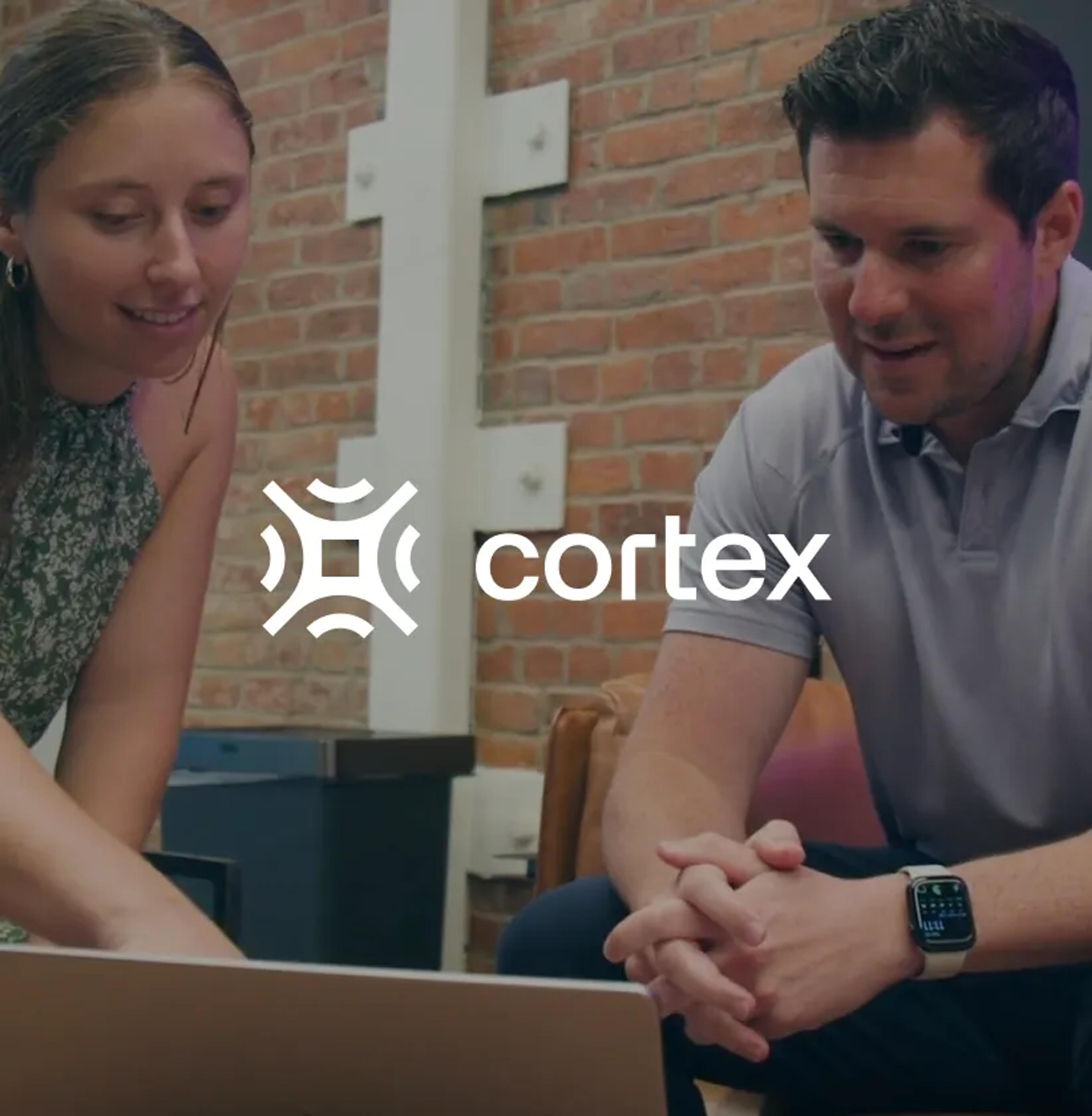 A man and woman looking at a laptop, with the Cortex logo superimposed.