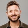 Smiling man with a beard.
