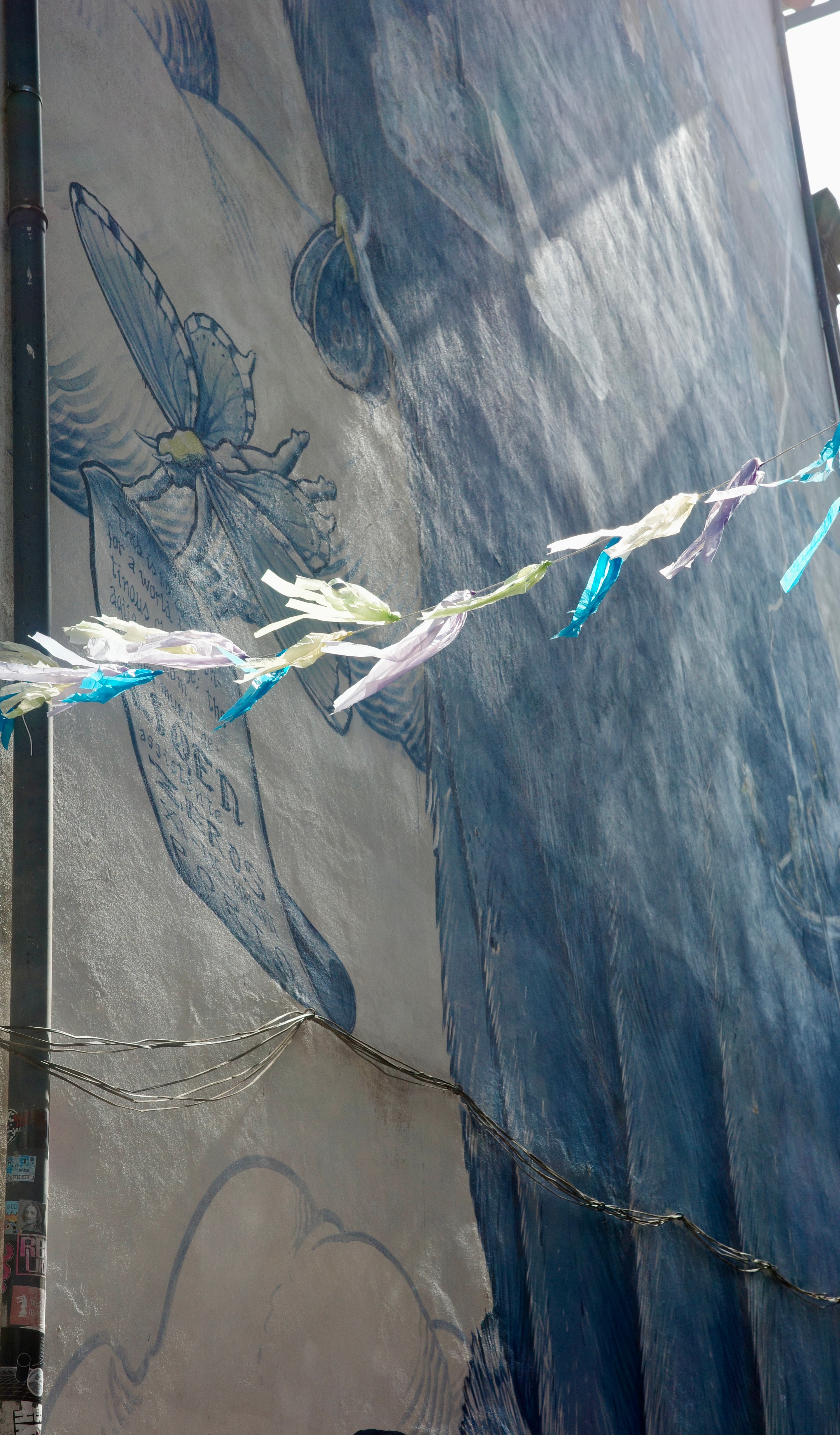 A frayed white cord crosses a blue patterned surface.