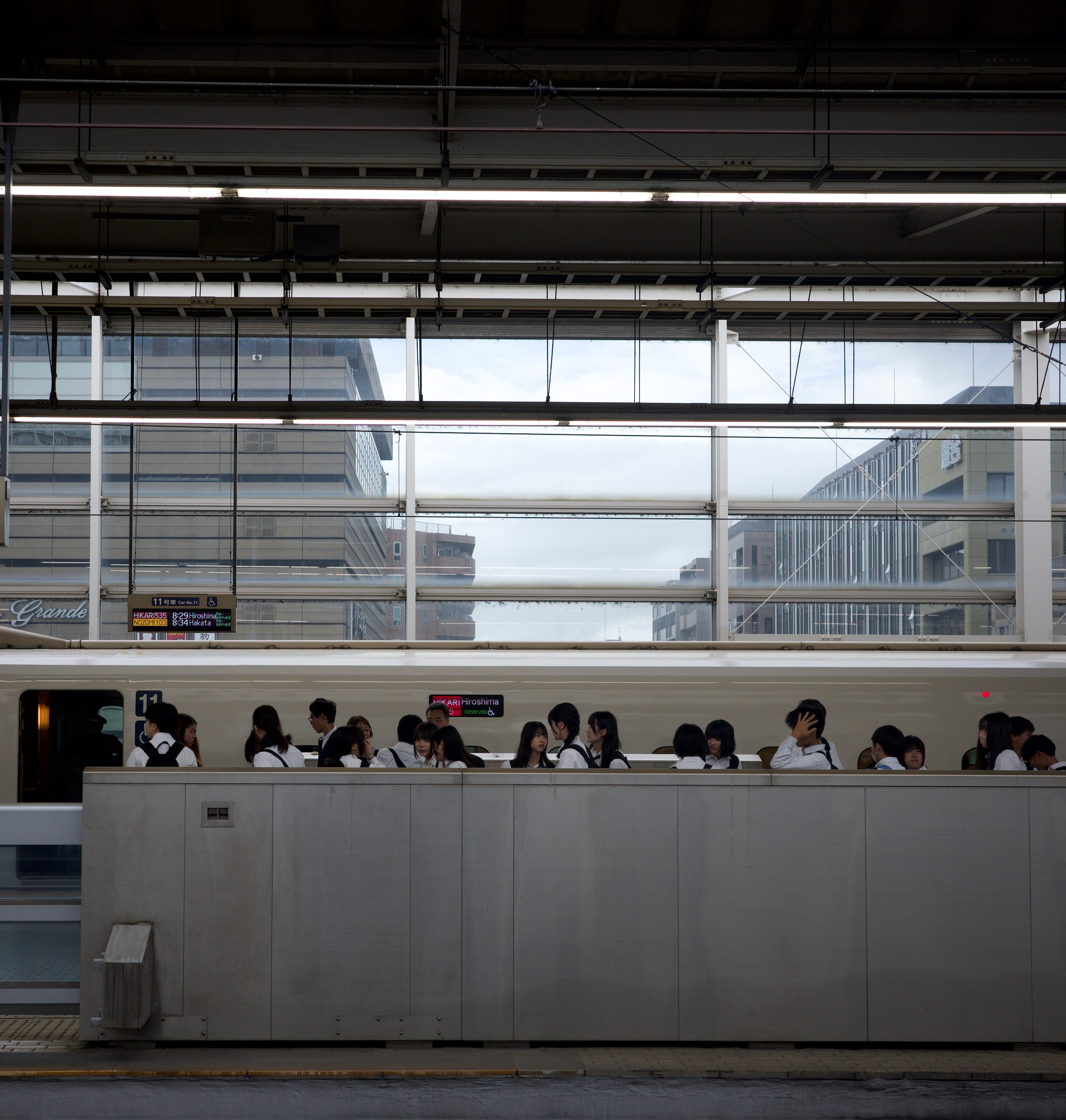 Diners sit behind a restaurant counter.