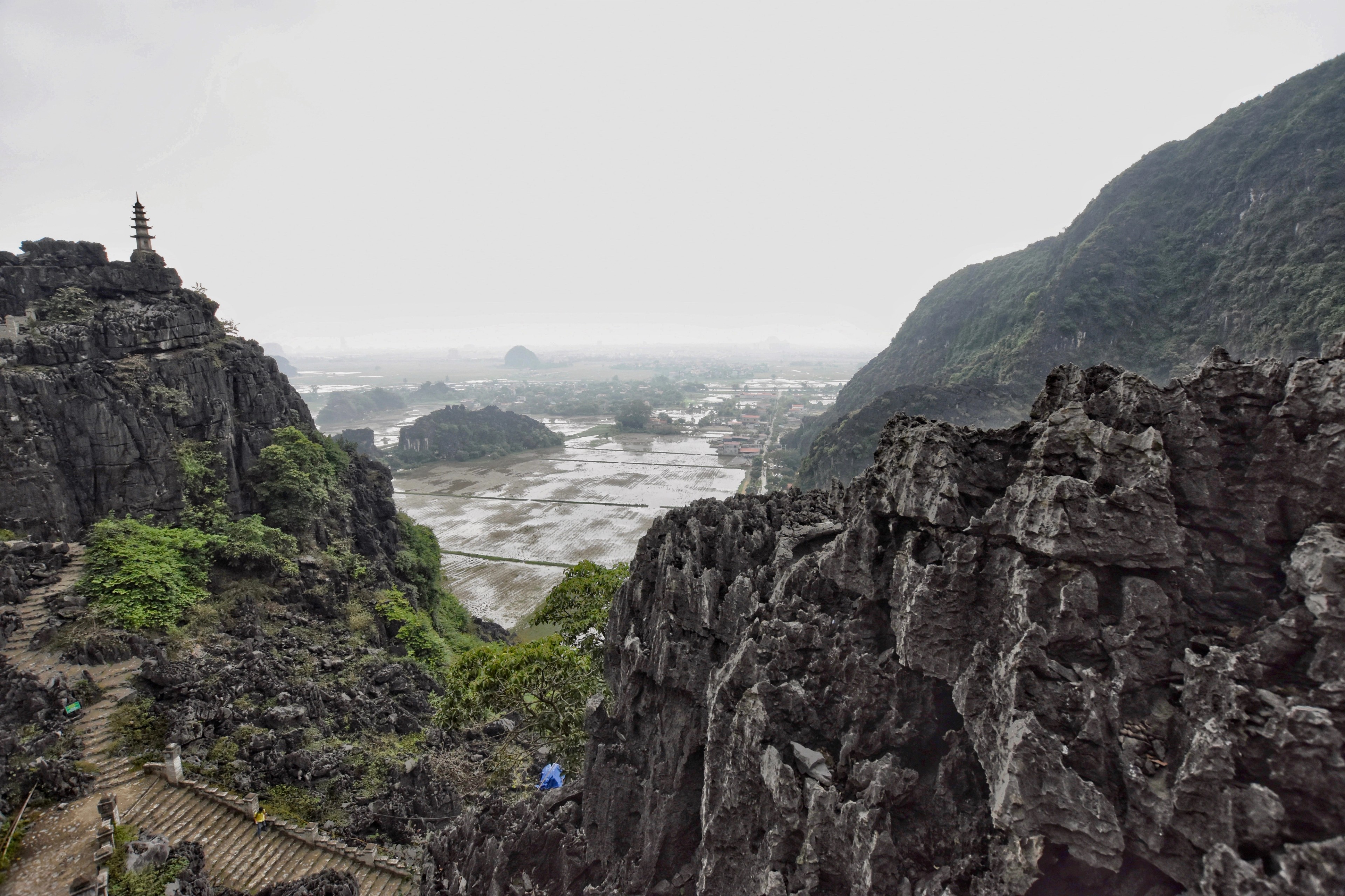 A narrow waterway passes between steep rocky cliffs and trees.