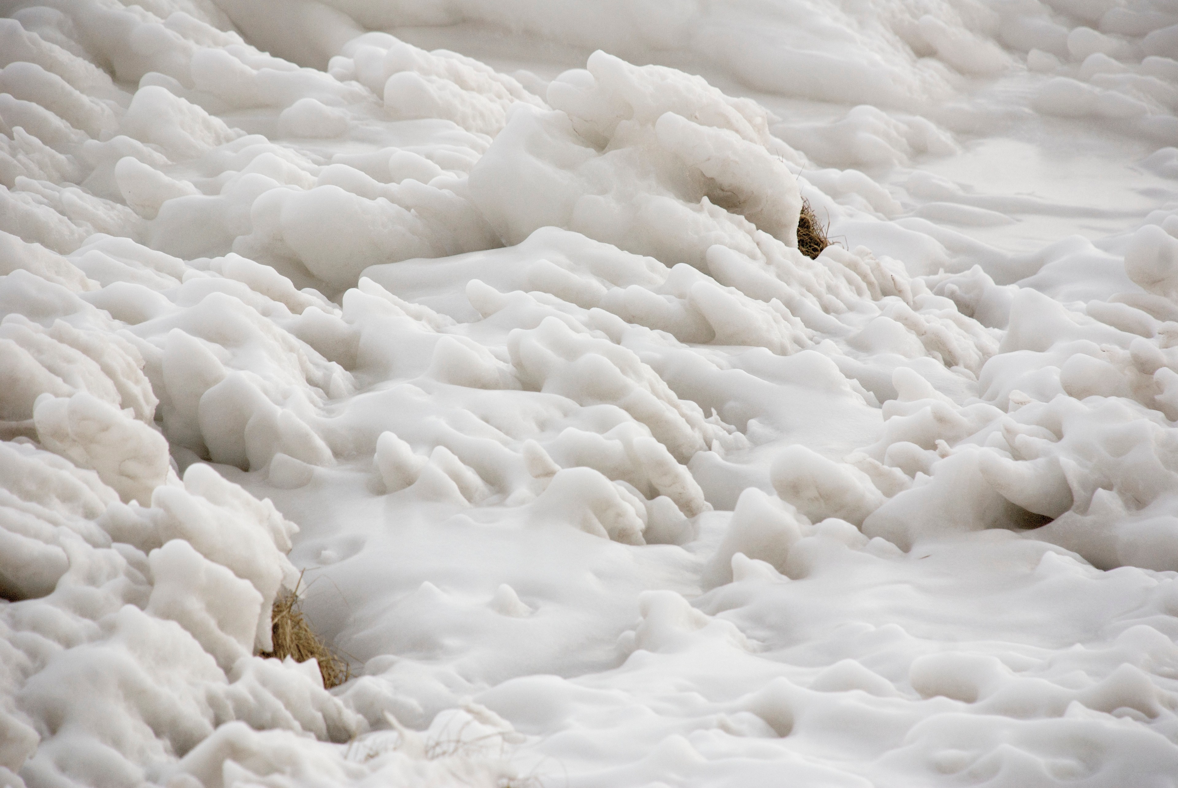 A close view of rippled white ice and snow.