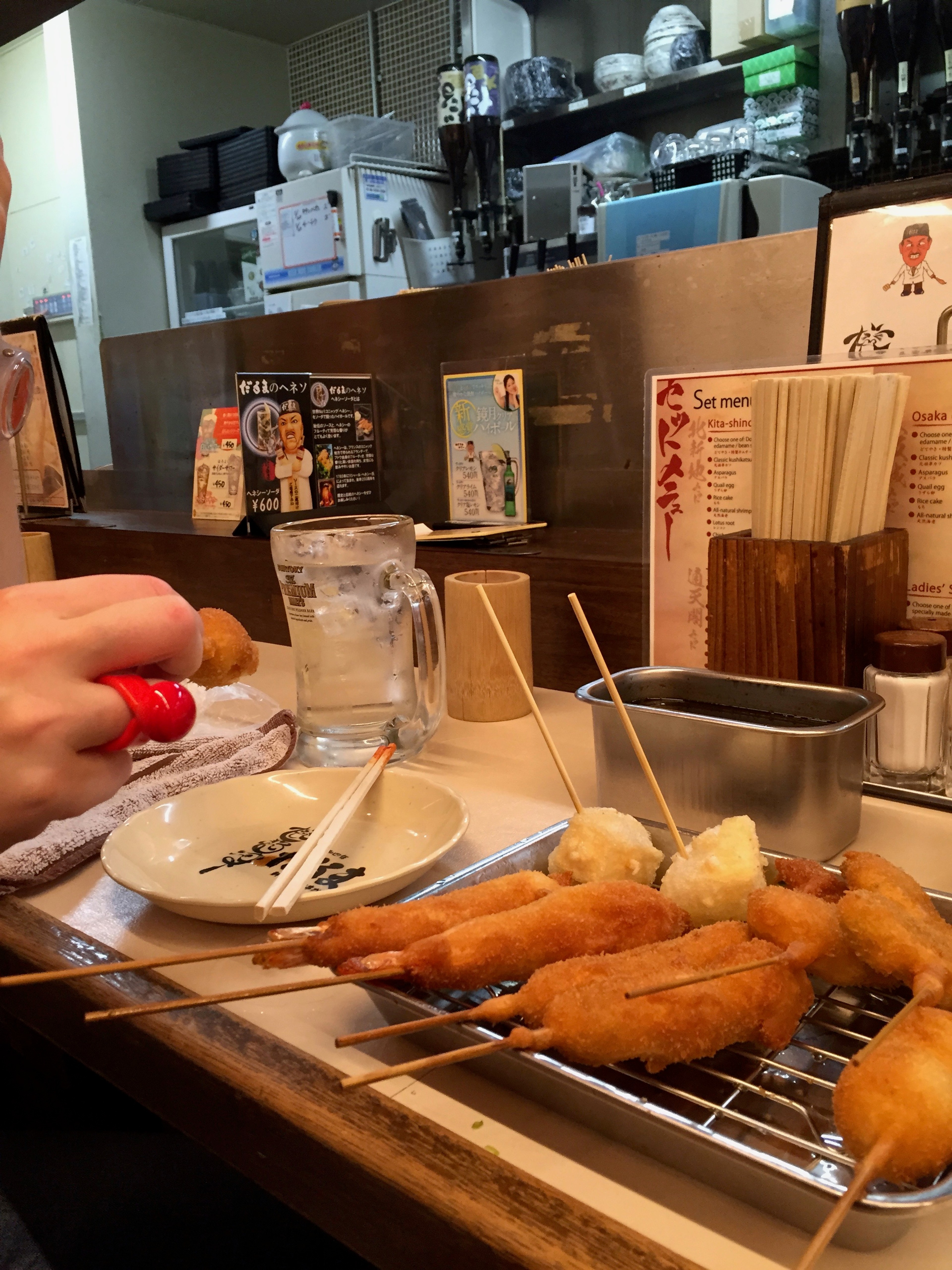 Food cooks on a metal grill inside a restaurant.