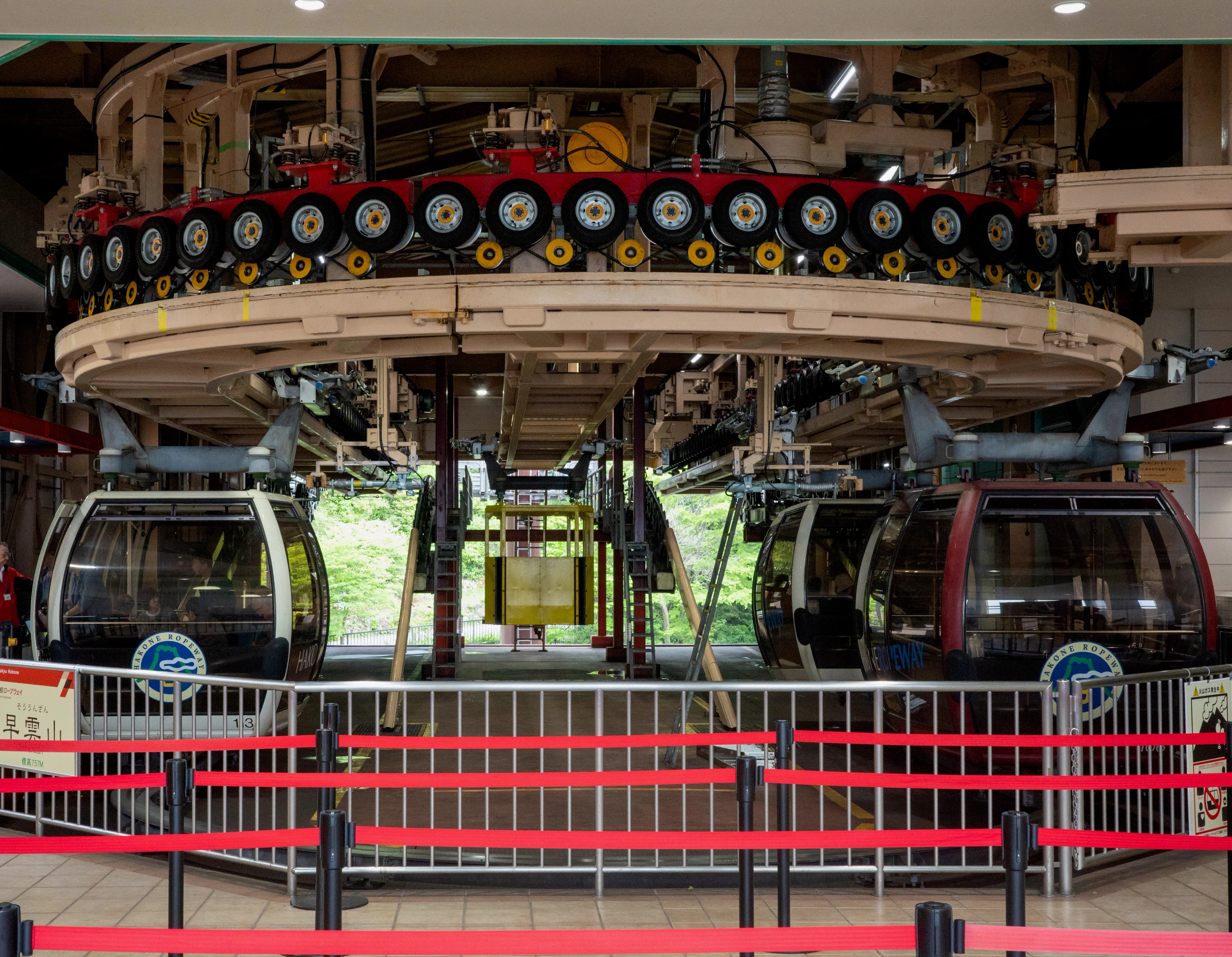 A row of cable cars waits at a station.