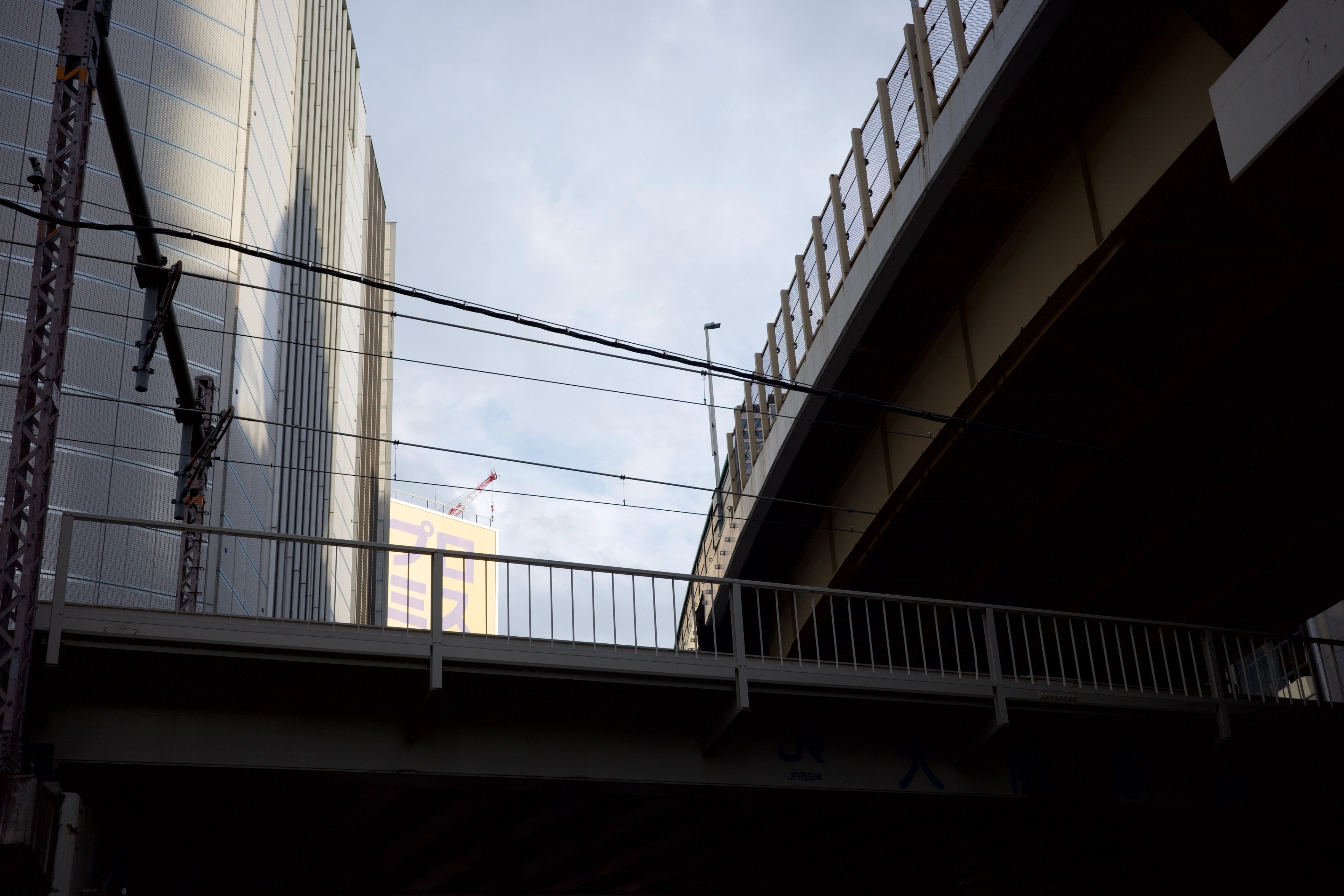 An elevated walkway crosses above a quiet road.