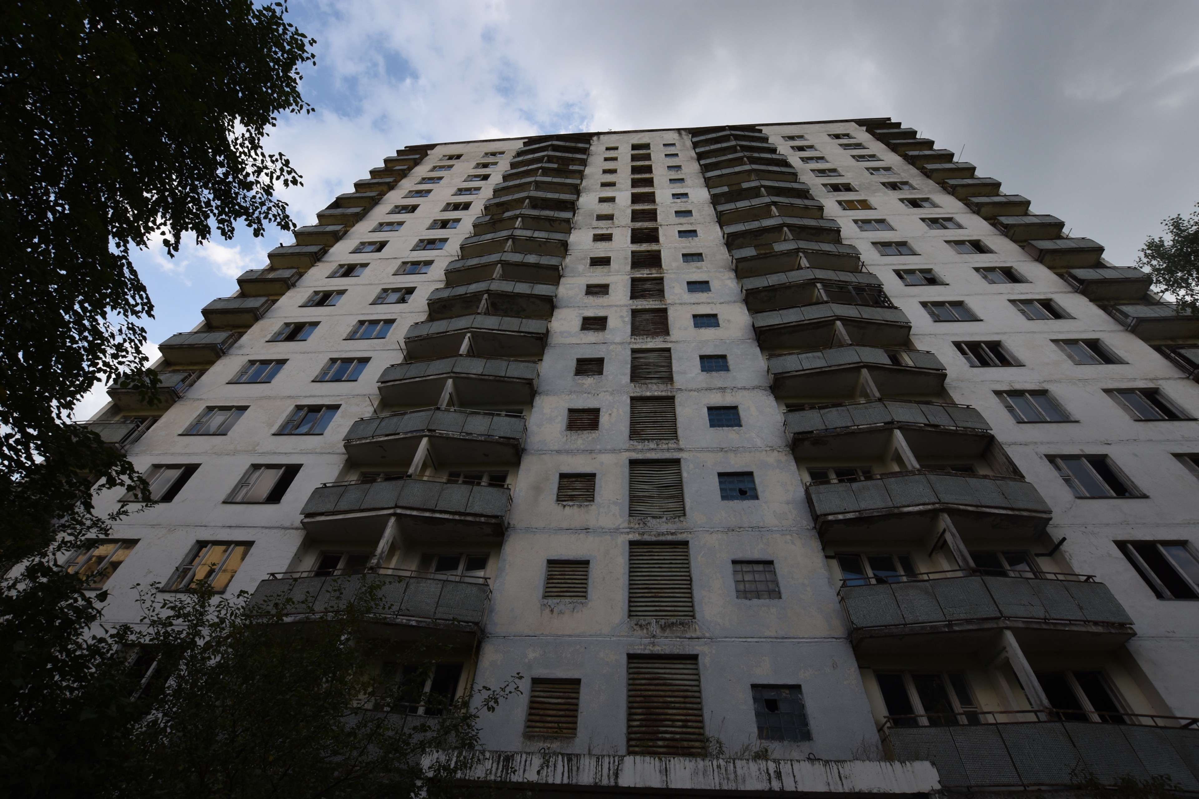 An apartment block viewed from directly below.