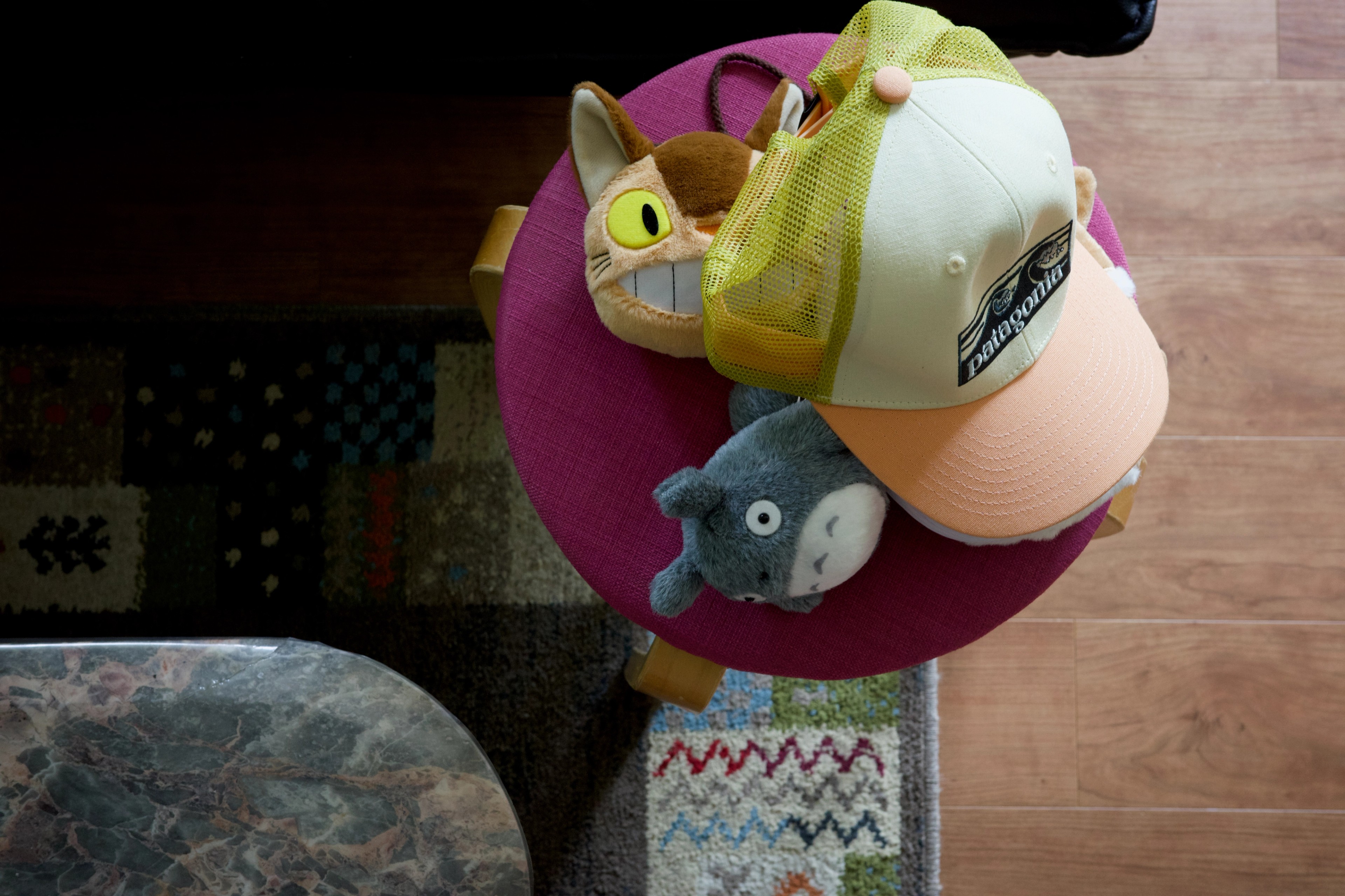 A colorful character toy rests on a wooden surface.