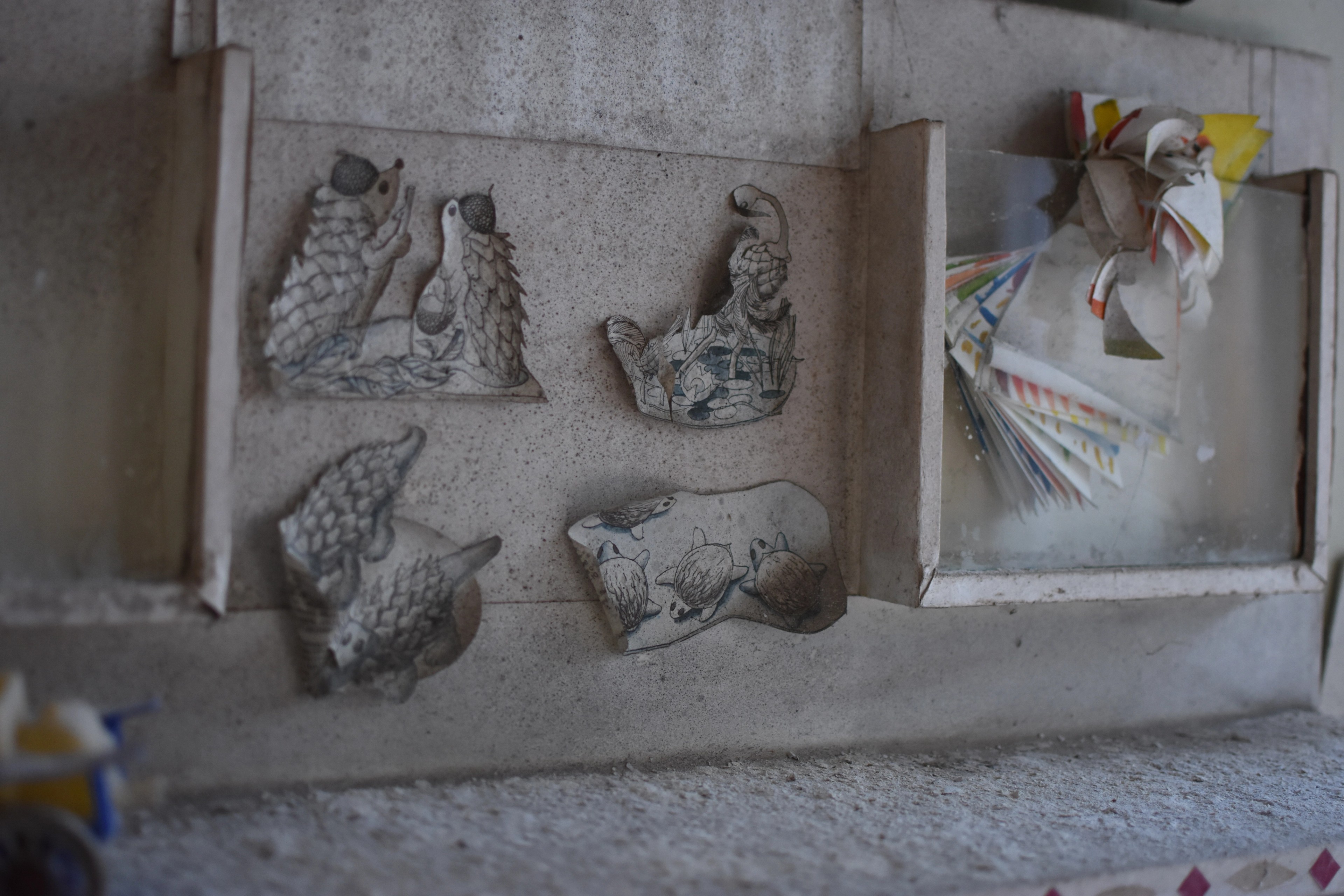 Decorative relief panels cover a weathered wall.