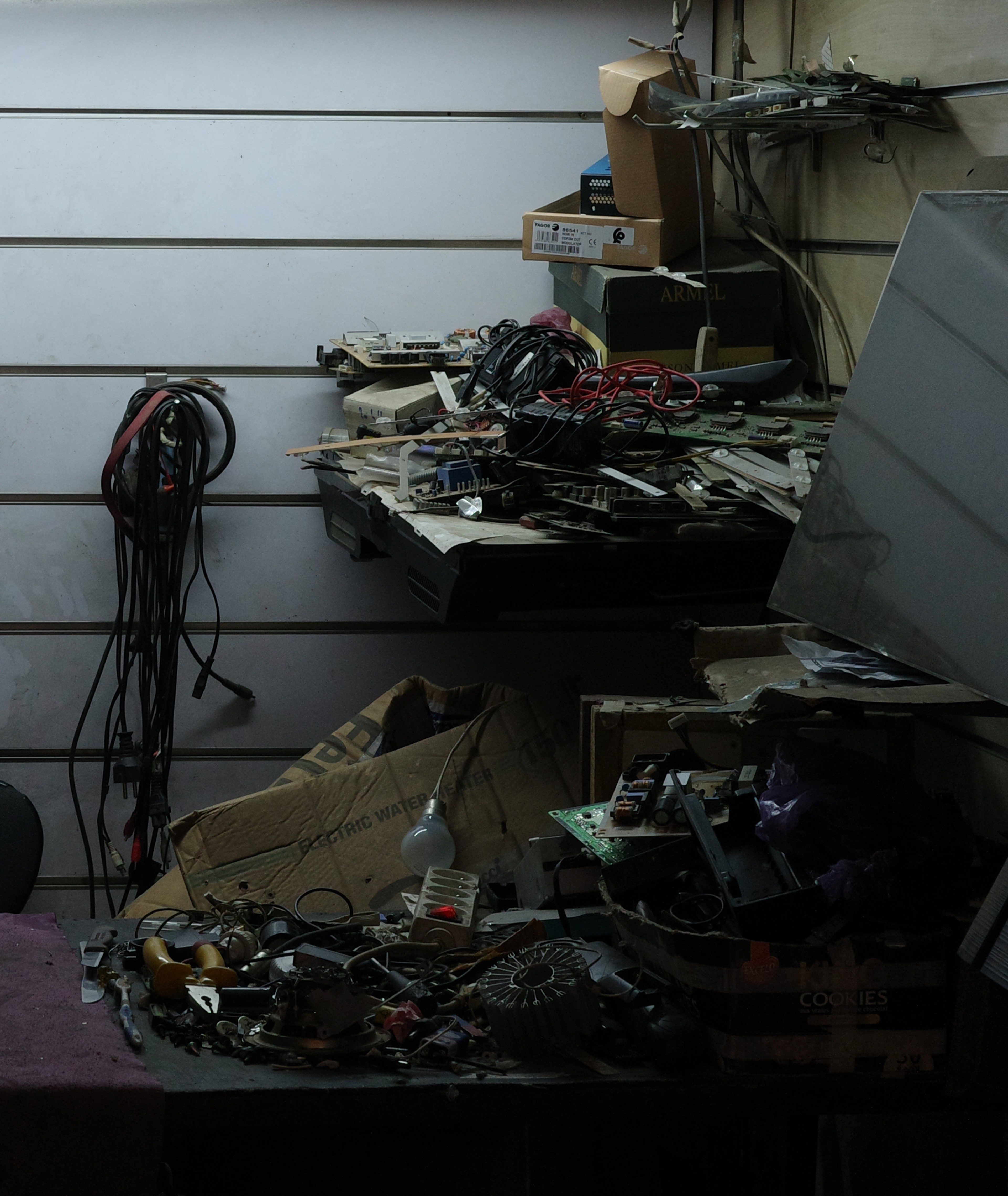 Several sewing machines and tools fill a cluttered workroom.