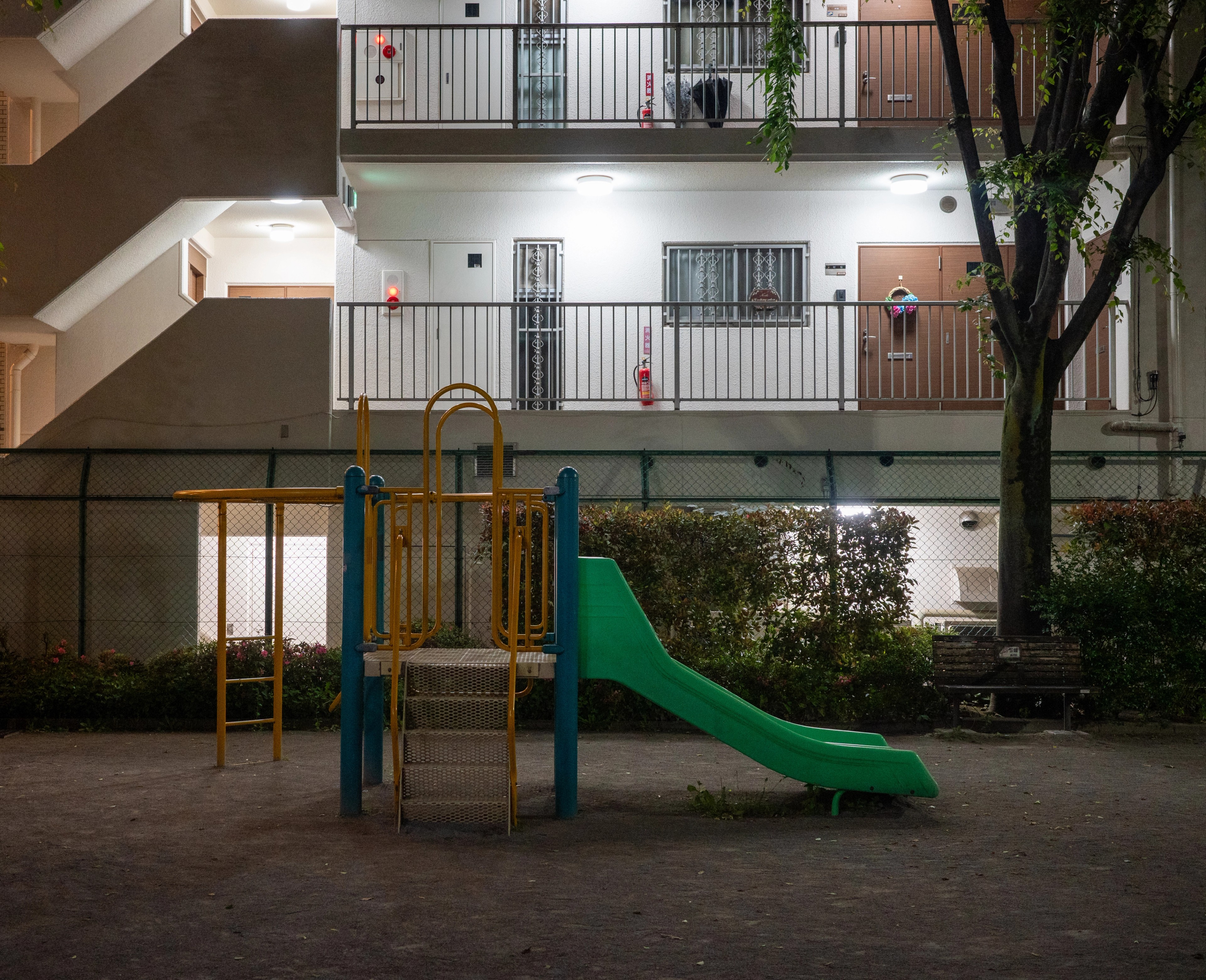 A small playground sits inside an apartment courtyard.