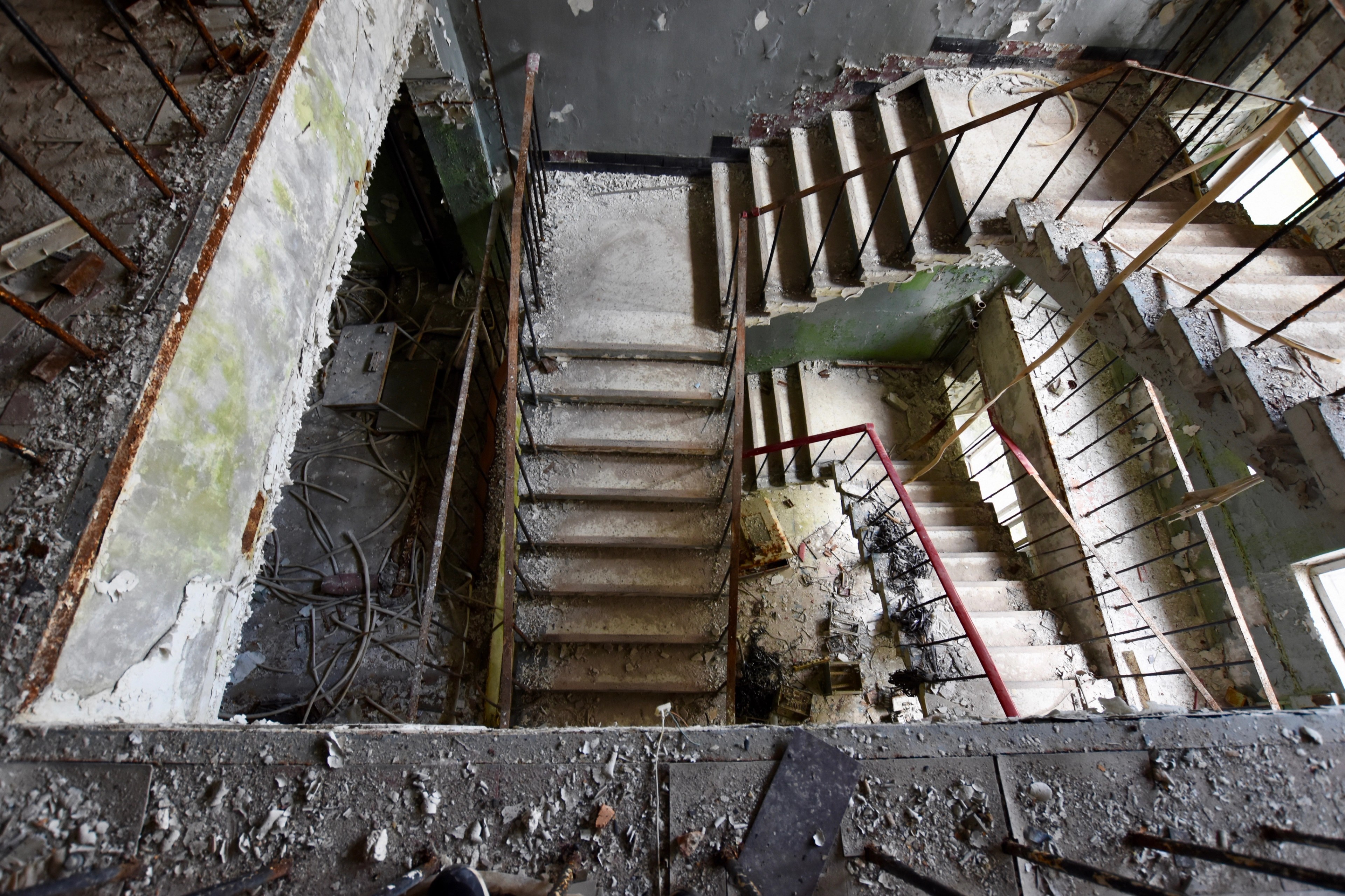 A deteriorated stairwell viewed from above.