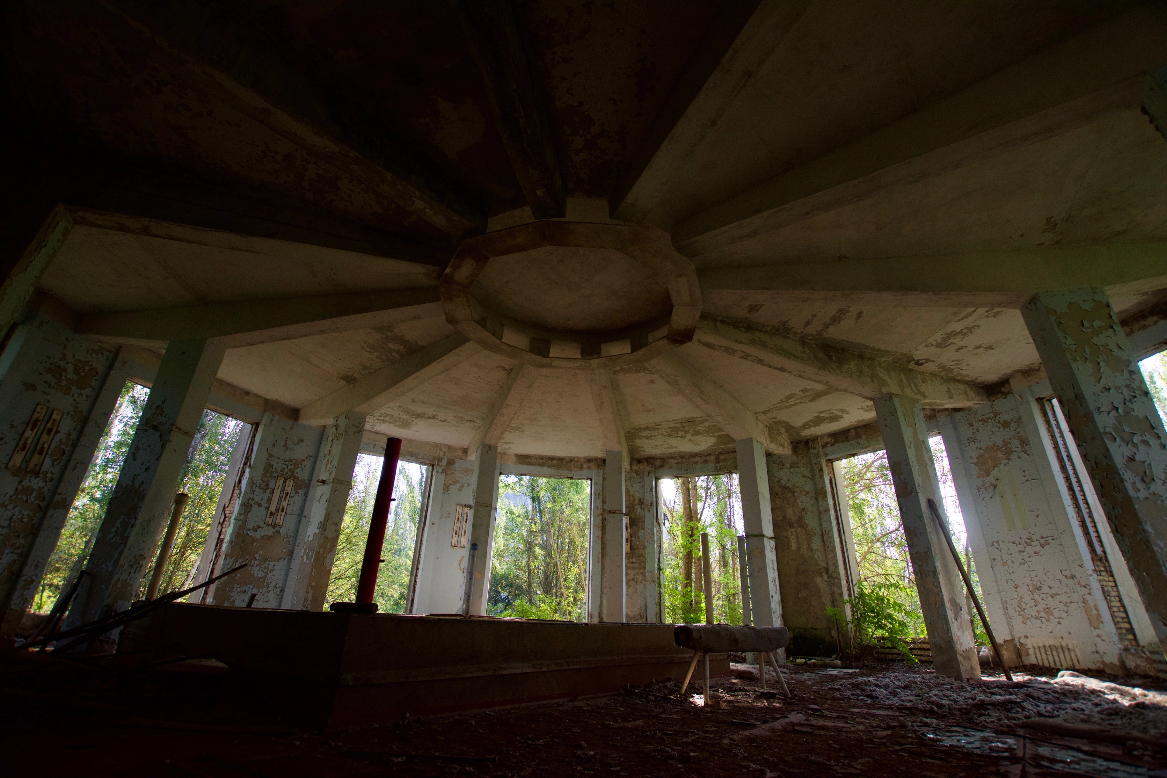 A circular domed ceiling inside an abandoned building.