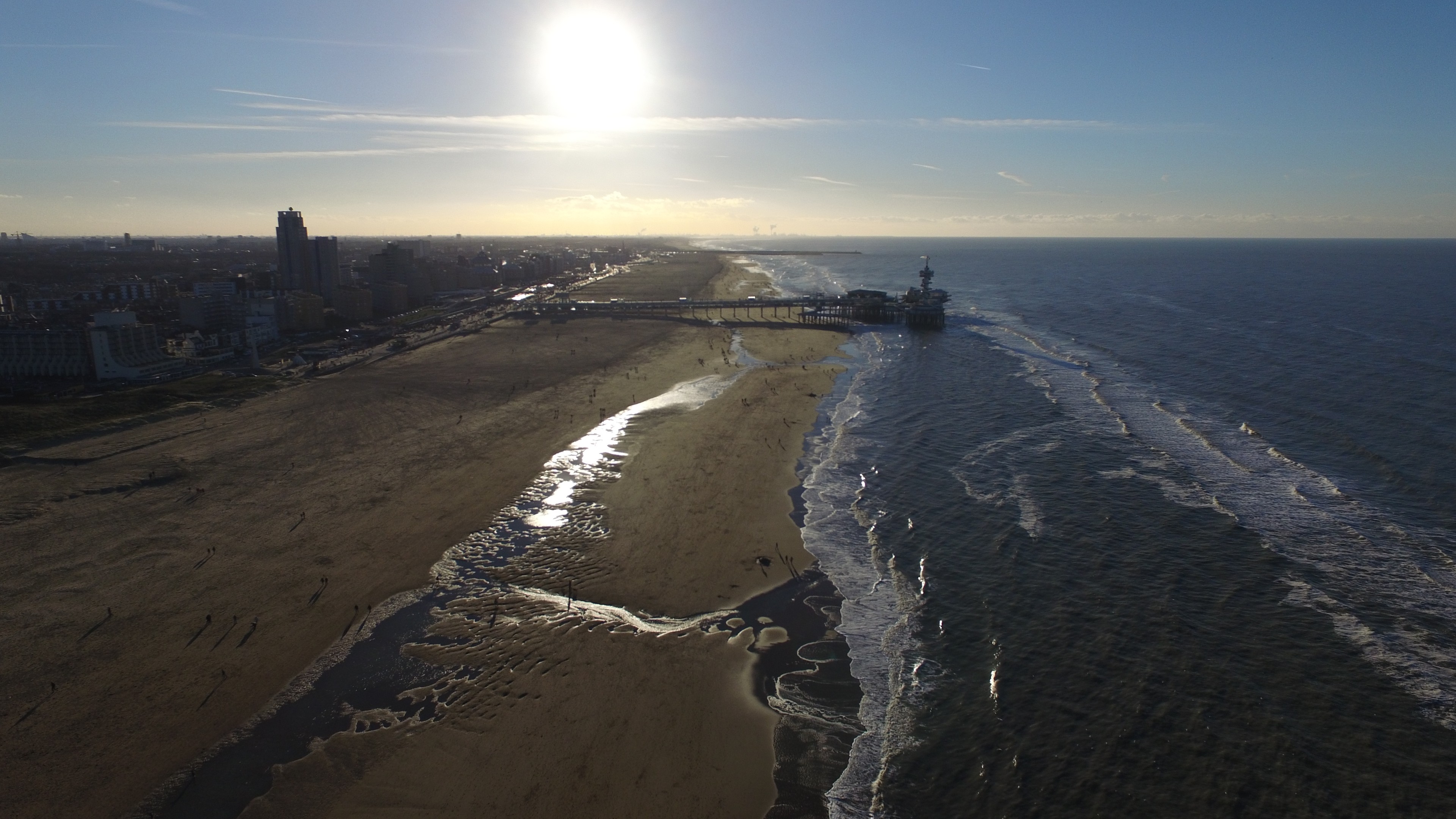 Aerial view of a beach and shoreline at low sun.