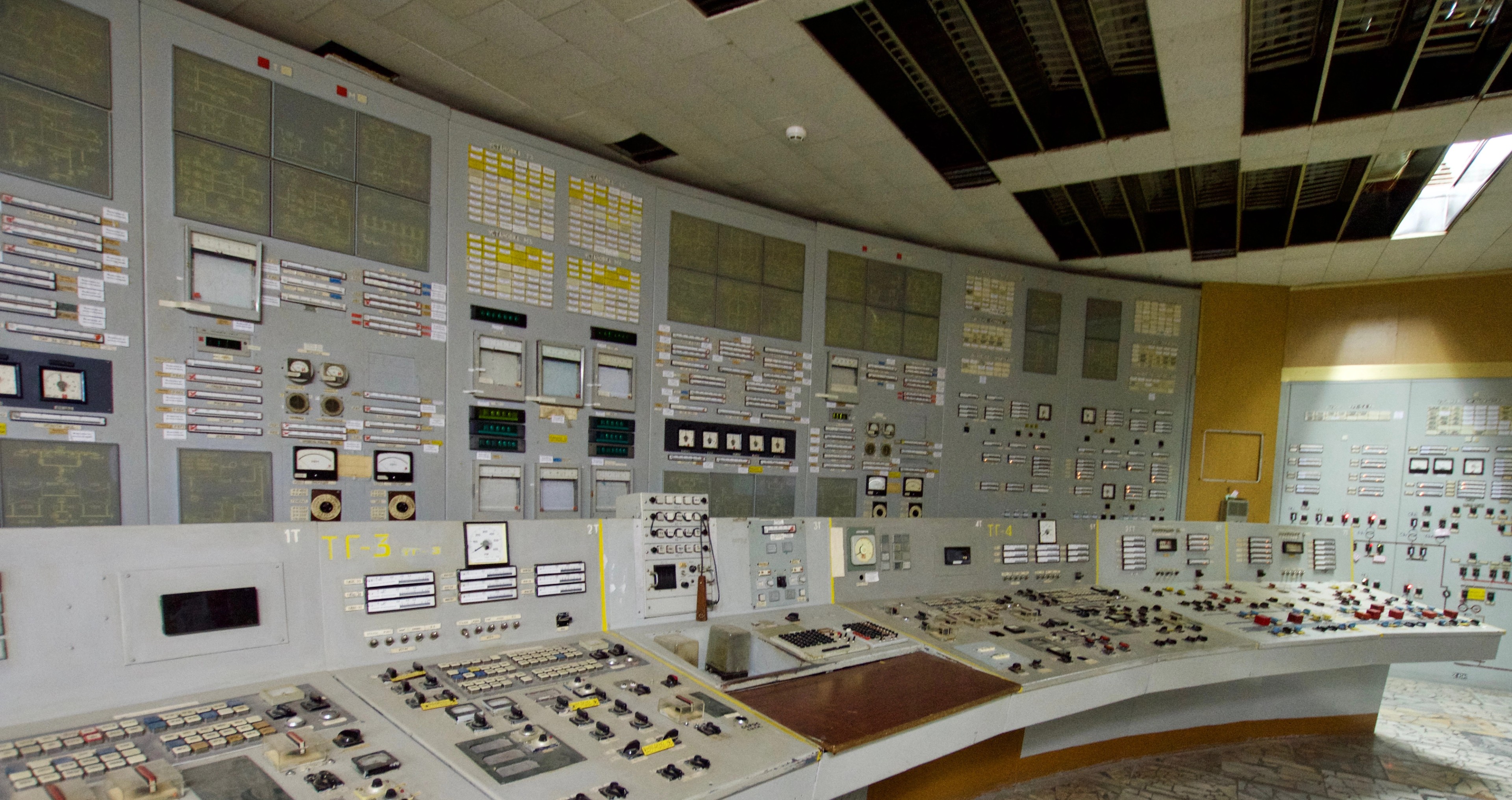 Rows of switches and control panels line an operations room.